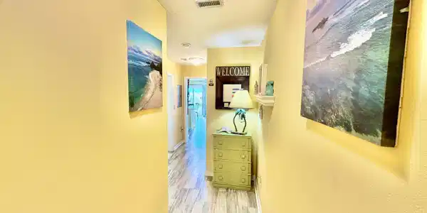 Image 3: Hallway featuring light-toned wood-finish flooring, warm-toned wall finishes, recessed lighting, and white baseboards