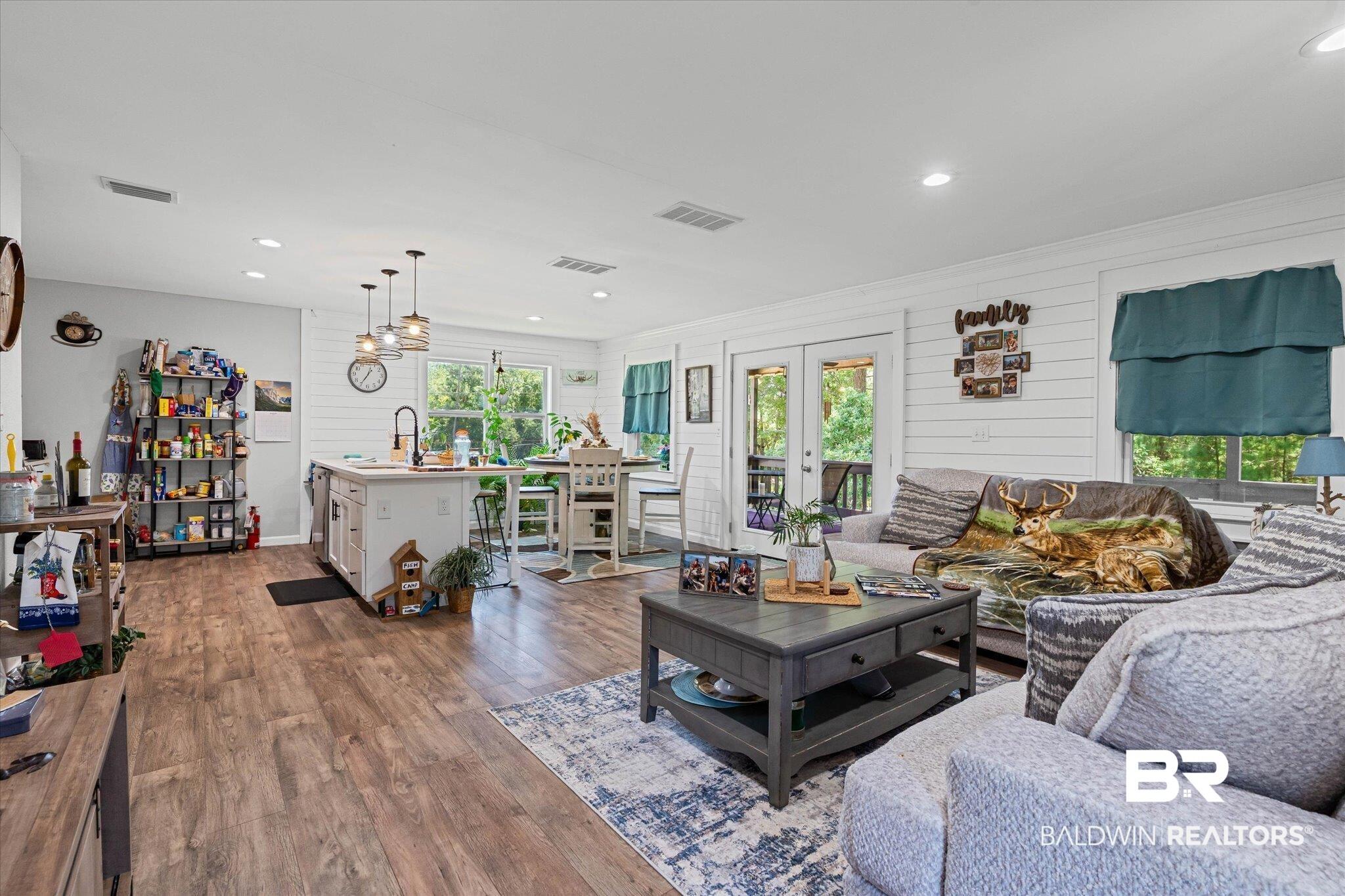 Image 3: Living area featuring dark wood finished floors, french doors, and recessed lighting