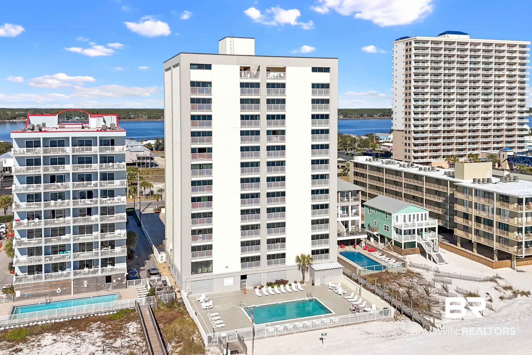 Image 2: View of apartment building / complex featuring a water view and a community pool