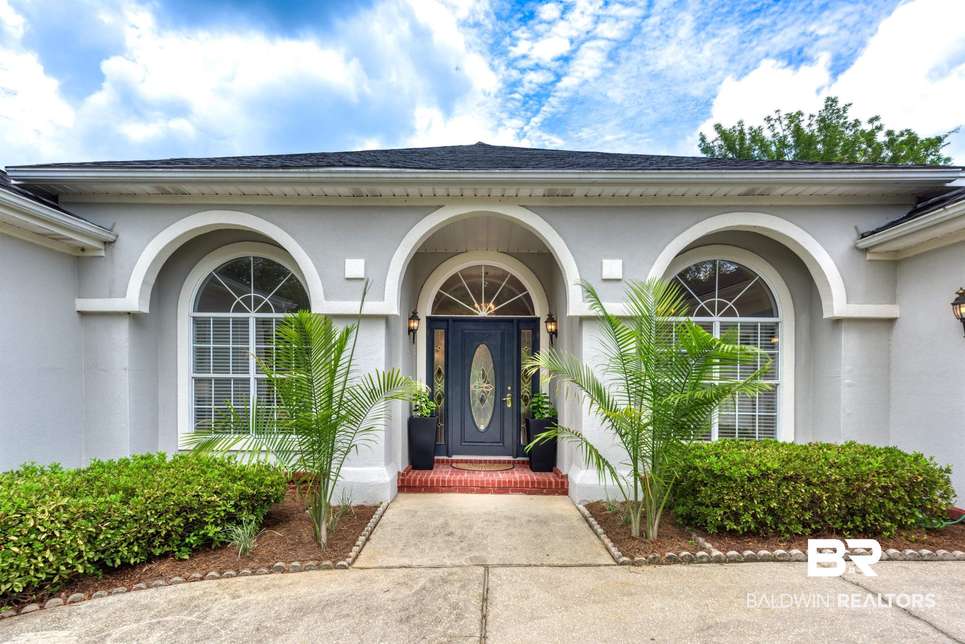 Image 2: Doorway to property featuring stucco siding and a shingled roof