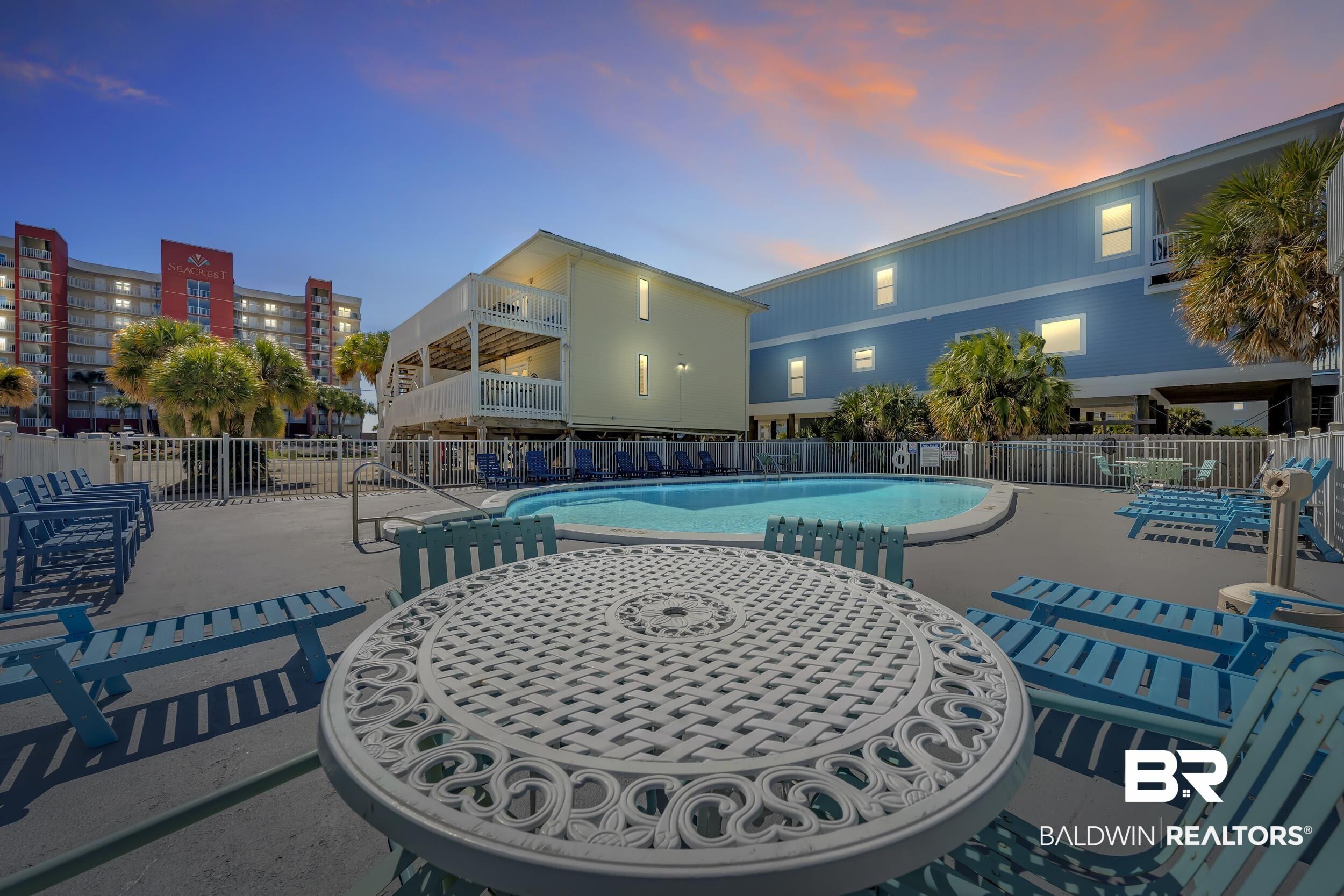 Image 3: Community pool featuring a patio area