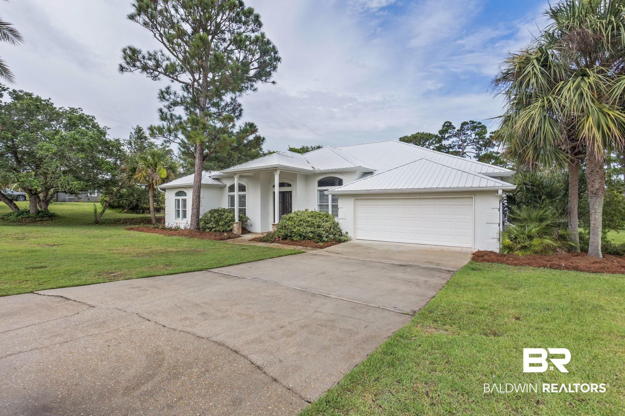 Image 3: Contemporary white stucco exterior with a metal roof