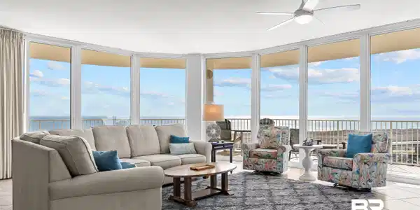 Image 2: Living room with light tile patterned flooring, expansive windows, a water view, and ceiling fan