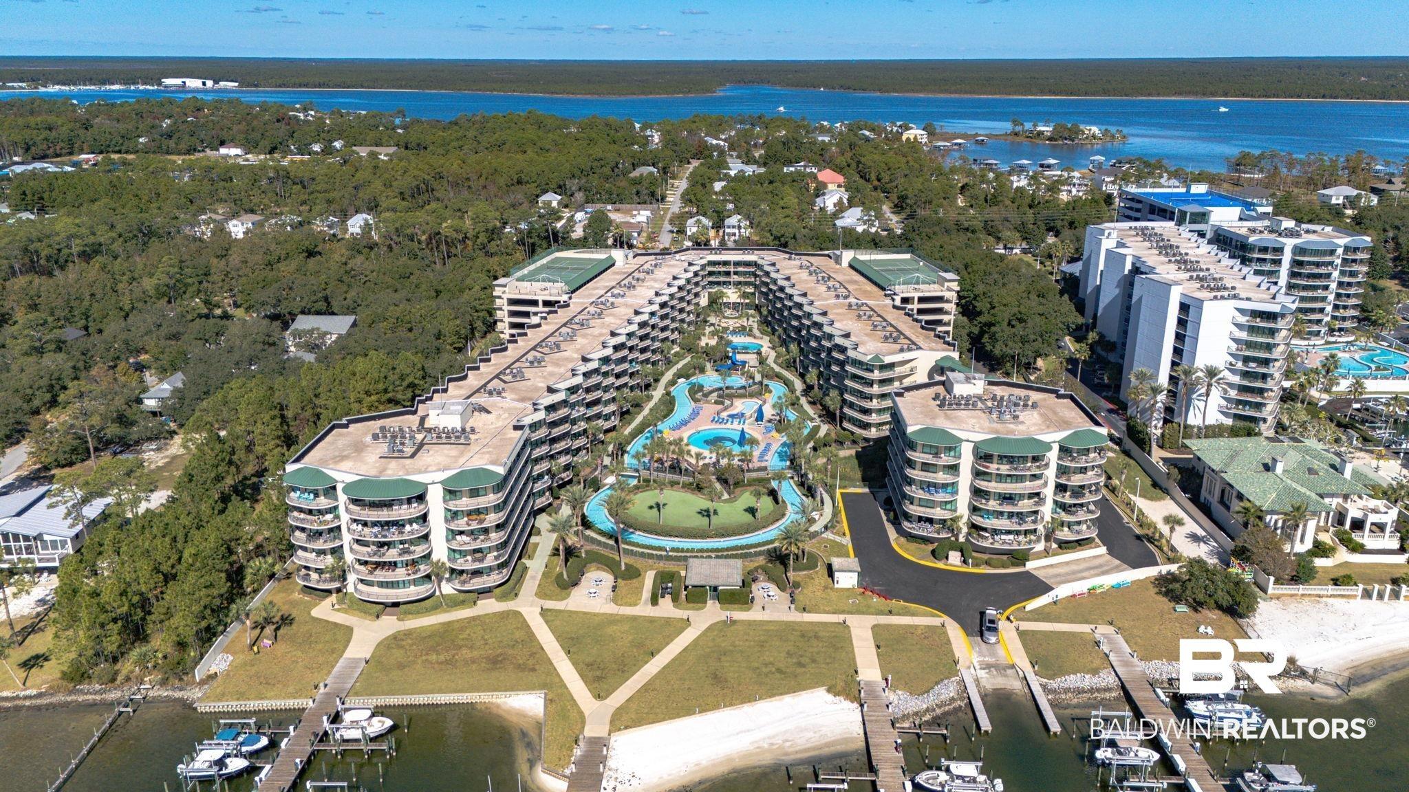 Image 3: Aerial view of property's location featuring a large body of water and apartment complex / building