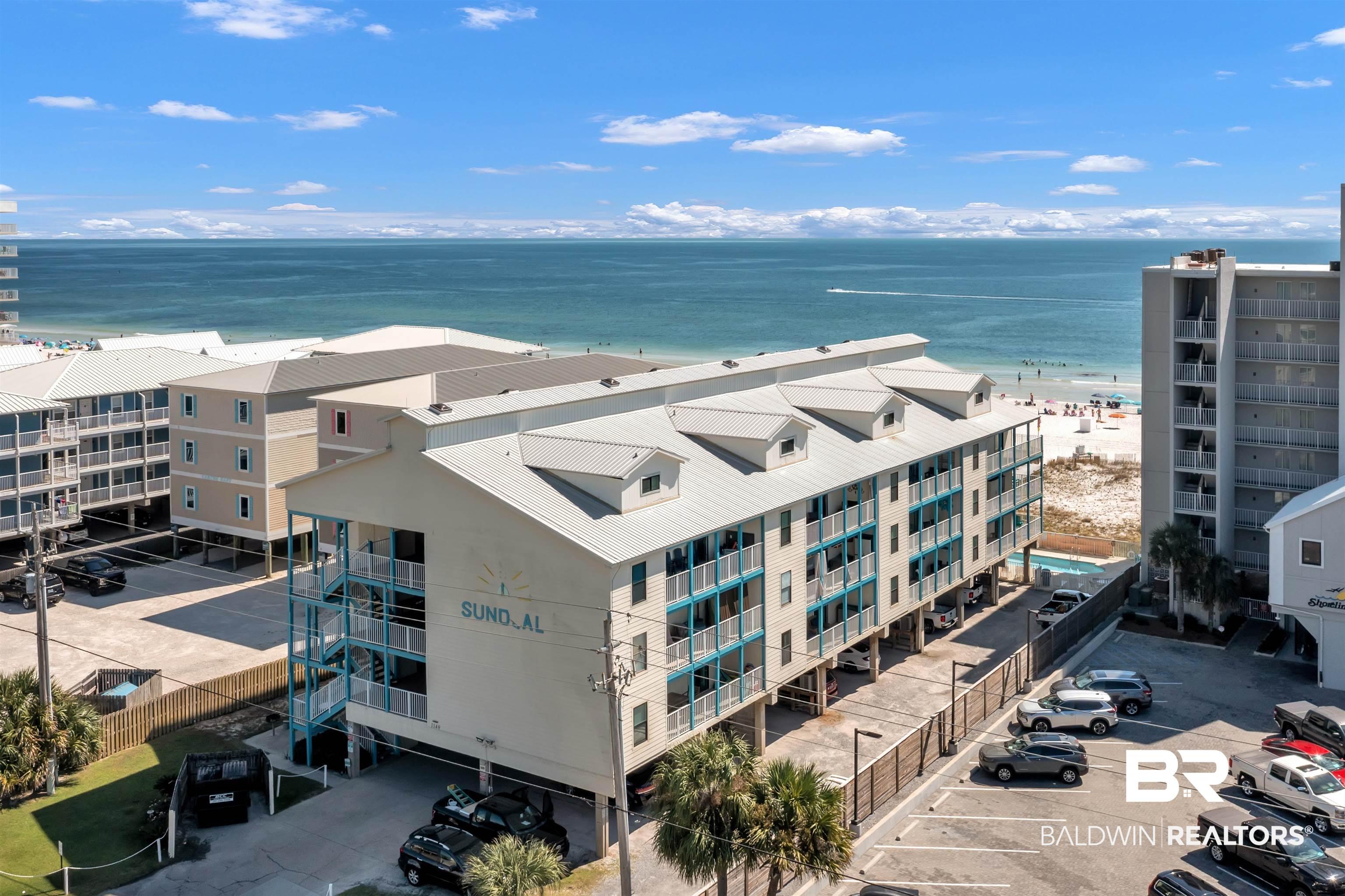 Image 1: Multi-story coastal building featuring a prominent oceanfront position