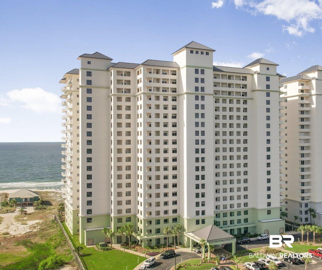 Image 1: View of apartment building / complex with a water view