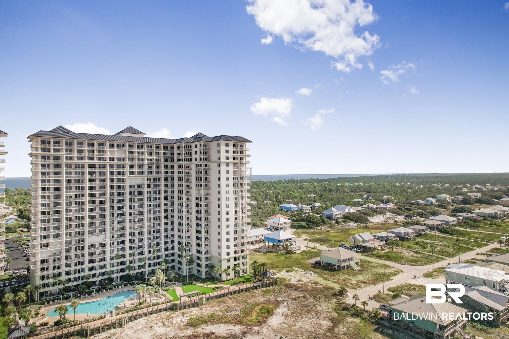 Image 2: Drone / aerial view of a pool area and apartment complex / building