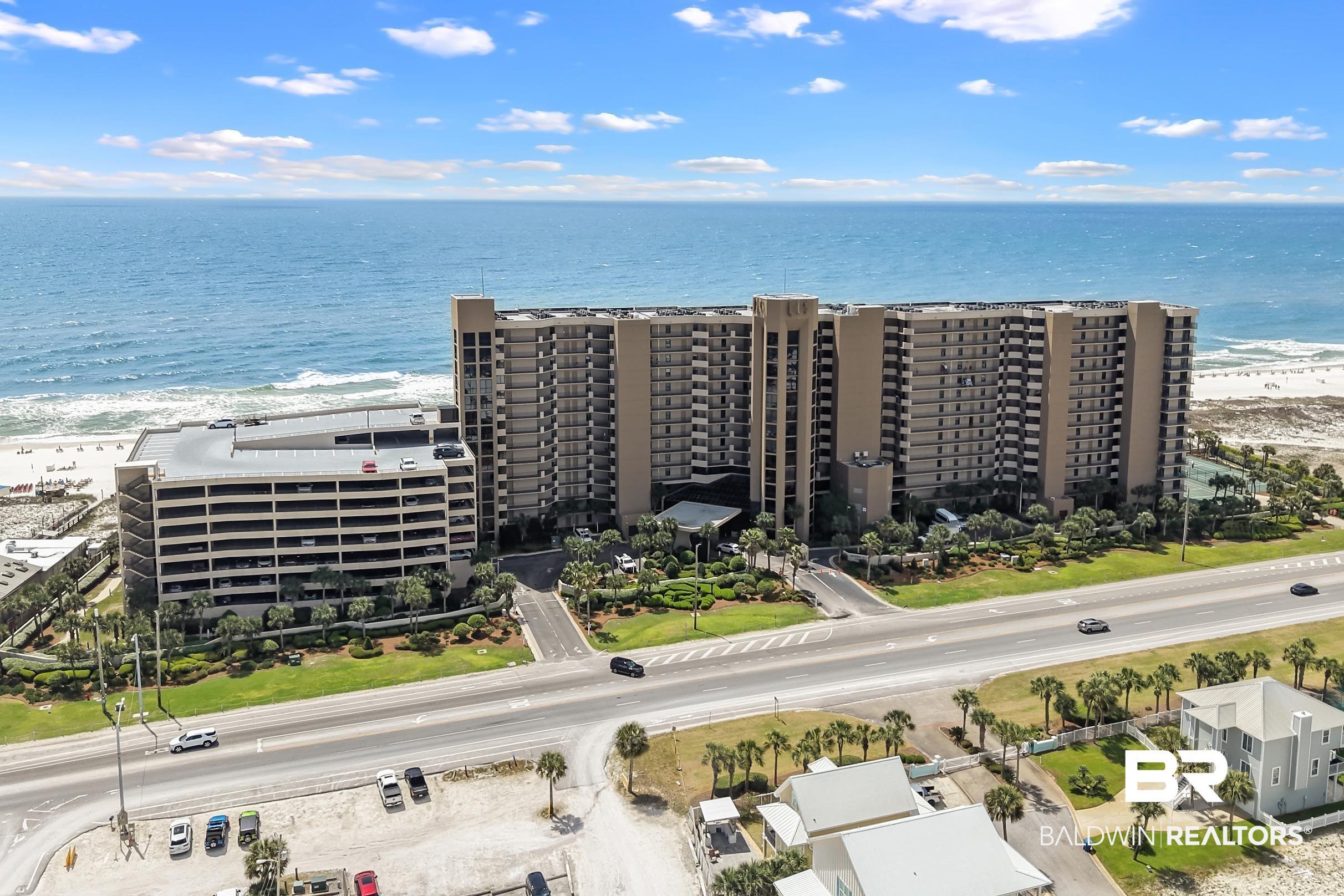 Image 2: Aerial view of apartment complex and unending shoreline