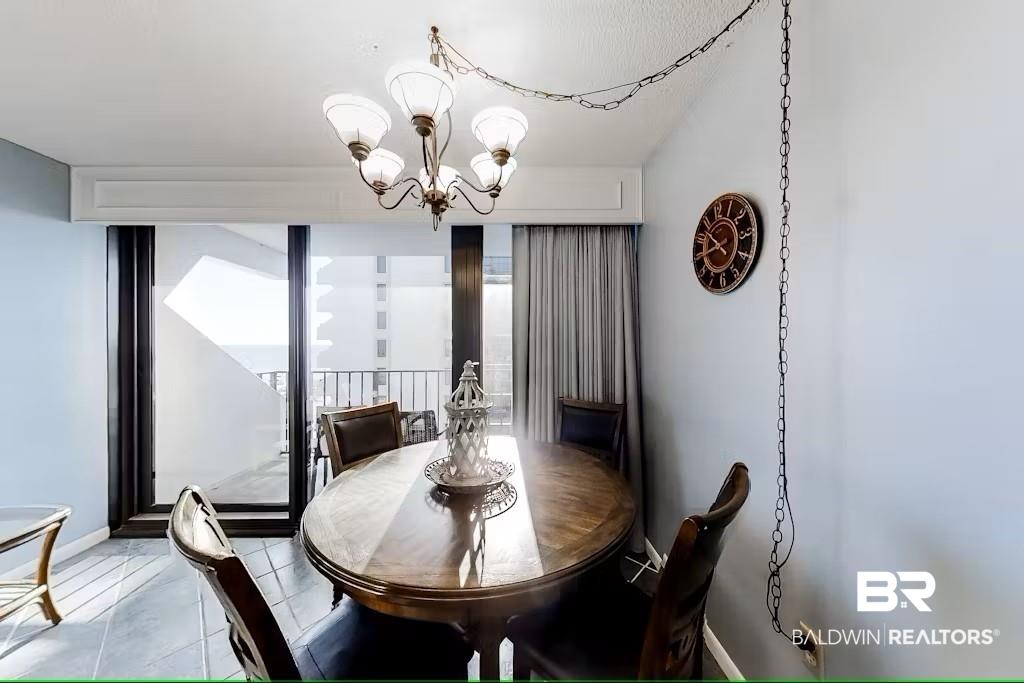 Image 4: Dining space featuring a notable chandelier