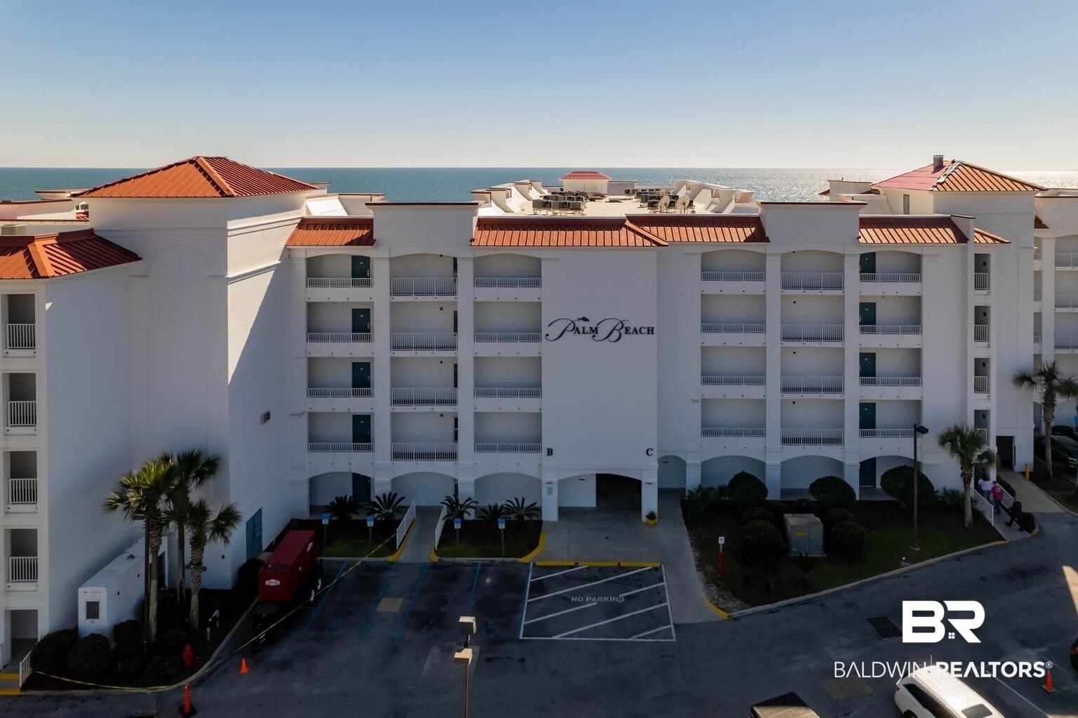 Image 3: View of property featuring a water view and uncovered parking