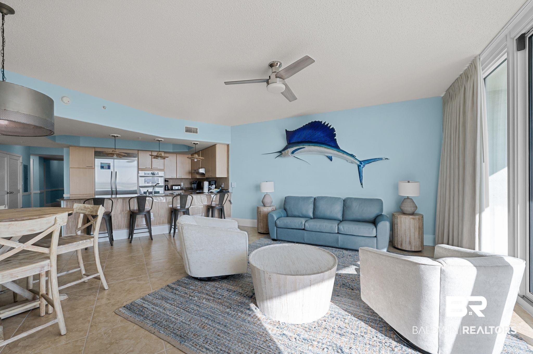 Image 4: Living room with ceiling fan and light tile patterned floors