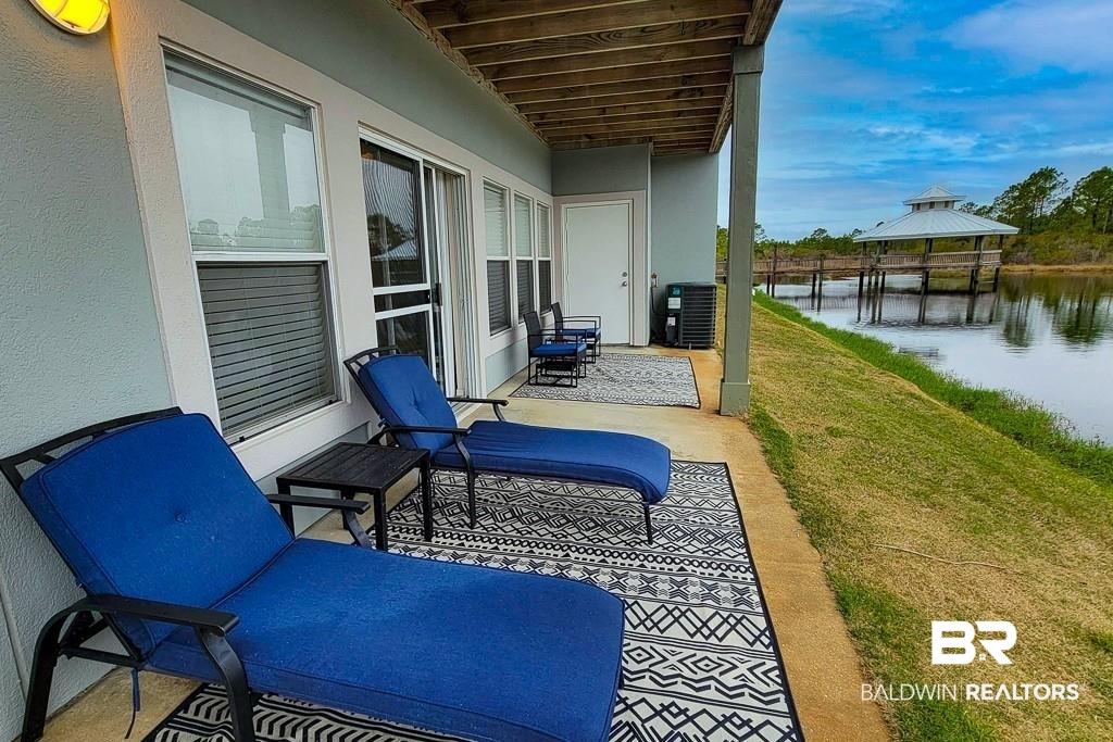 Image 2: Balcony featuring a water view