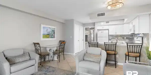 Image 3: Living room featuring light tile patterned flooring and baseboards