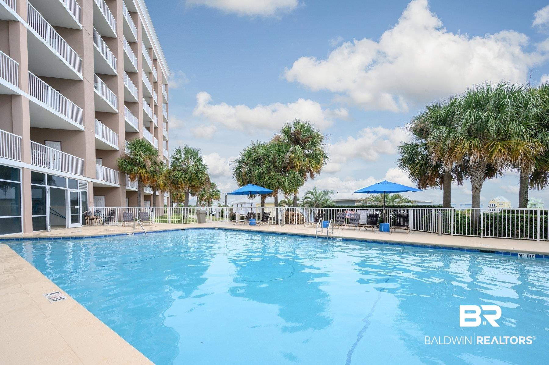 Image 2: Community pool with a patio