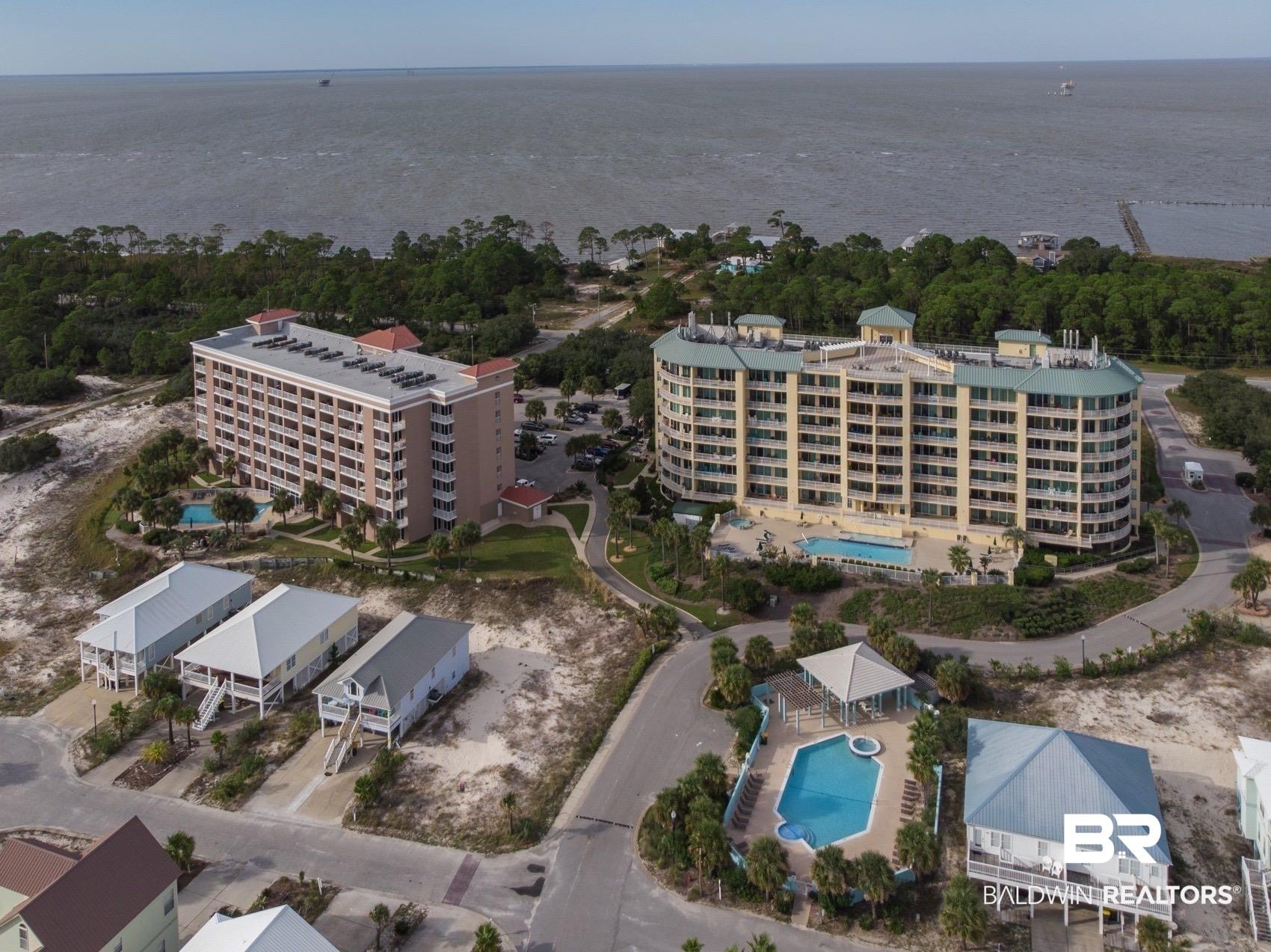 Image 4: Aerial view of a pool and a large body of water