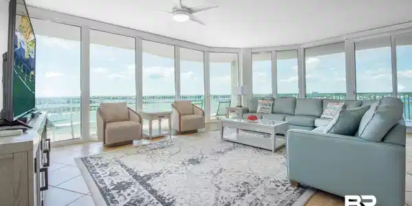 Image 2: Living room featuring a wall of windows and ceiling fan