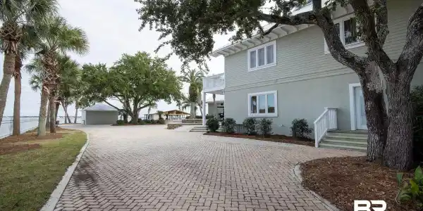Image 3: View of side of property featuring stucco siding, a wooden deck, and a balcony
