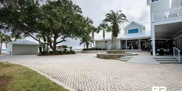 Image 4: Surrounding community with a patio area, decorative driveway, and a balcony