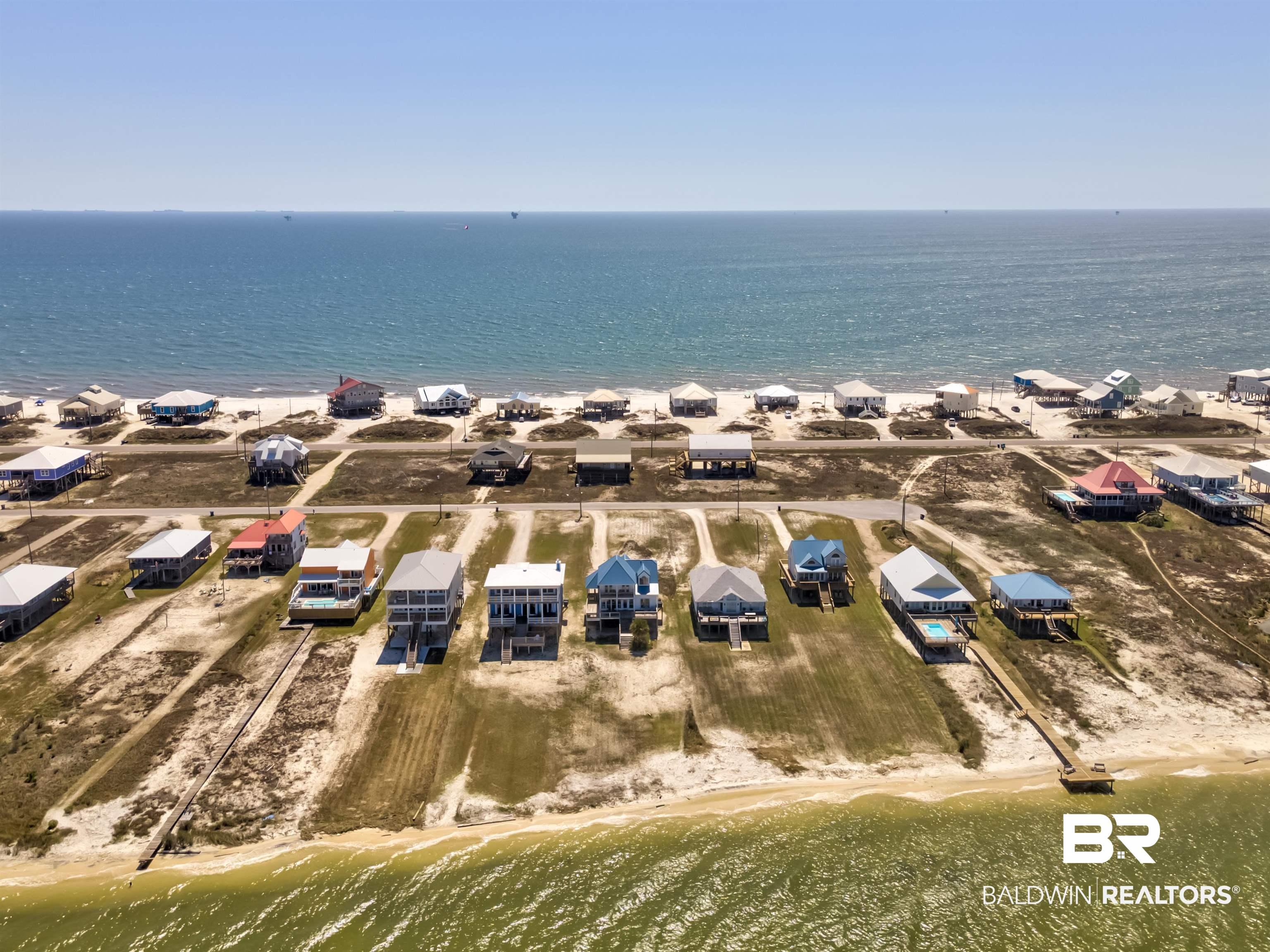 Image 3: Aerial view of property's location with waterfront with a beach and nearby suburban area