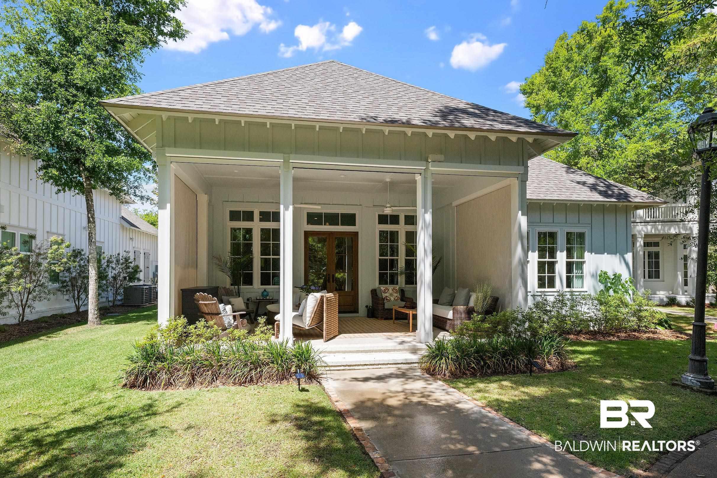 Image 2: Covered front porch featuring white columns and a beadboard ceiling