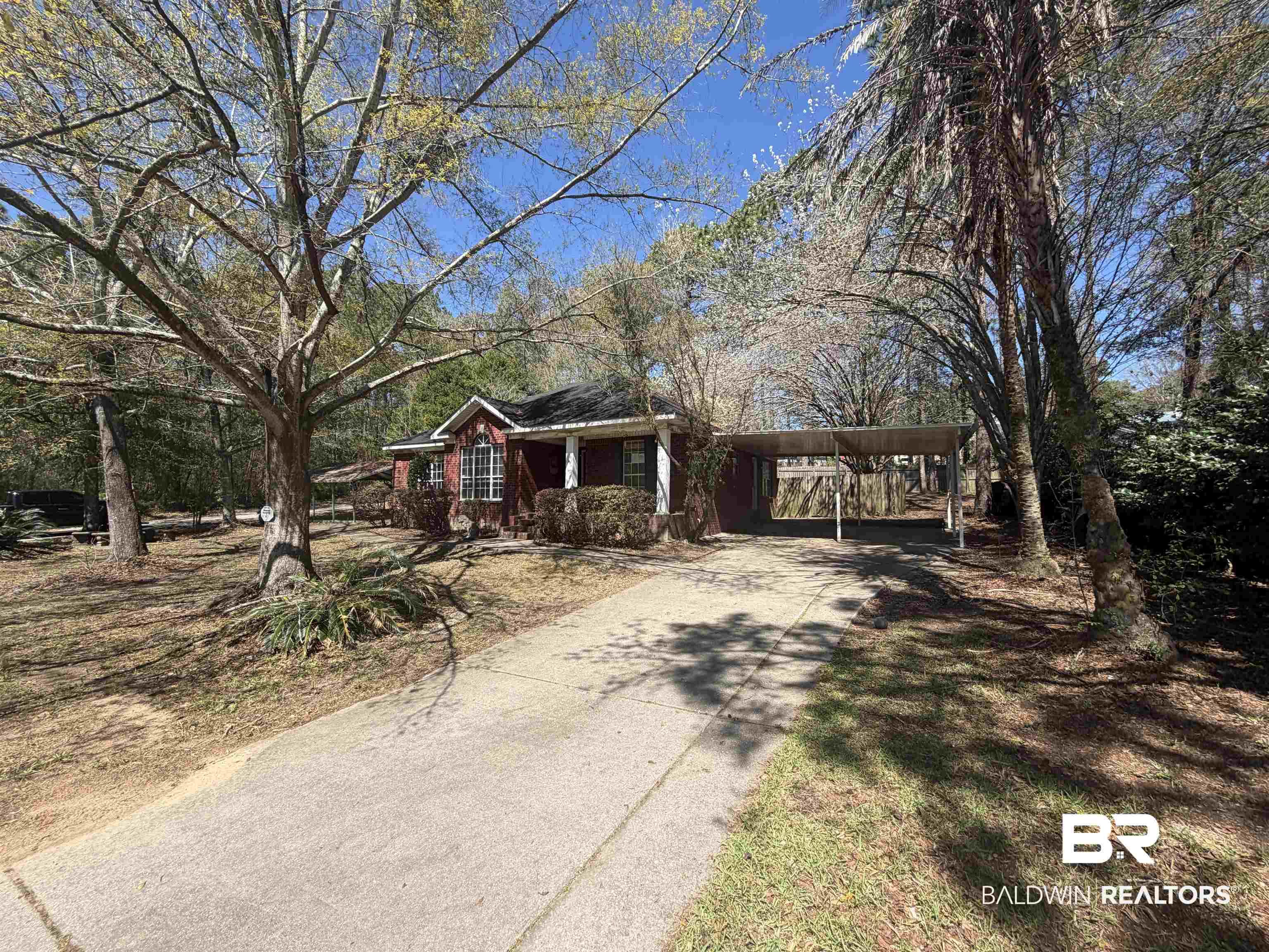 Image 4: Ranch-style home with driveway and a carport