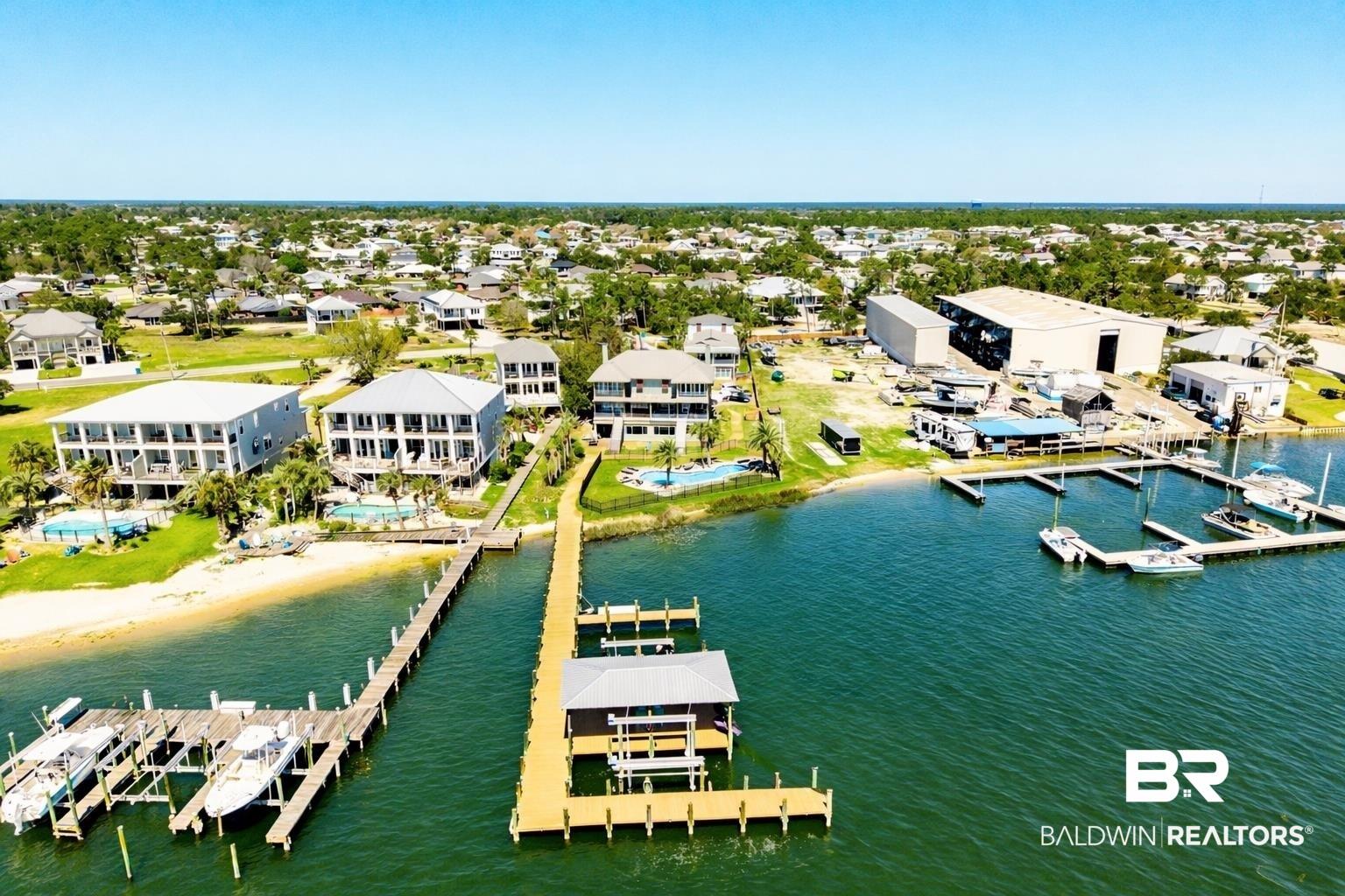 Image 3: Large property featuring dock, boat slip & lift, fenced-in pool for safety, and beautifully renovated home