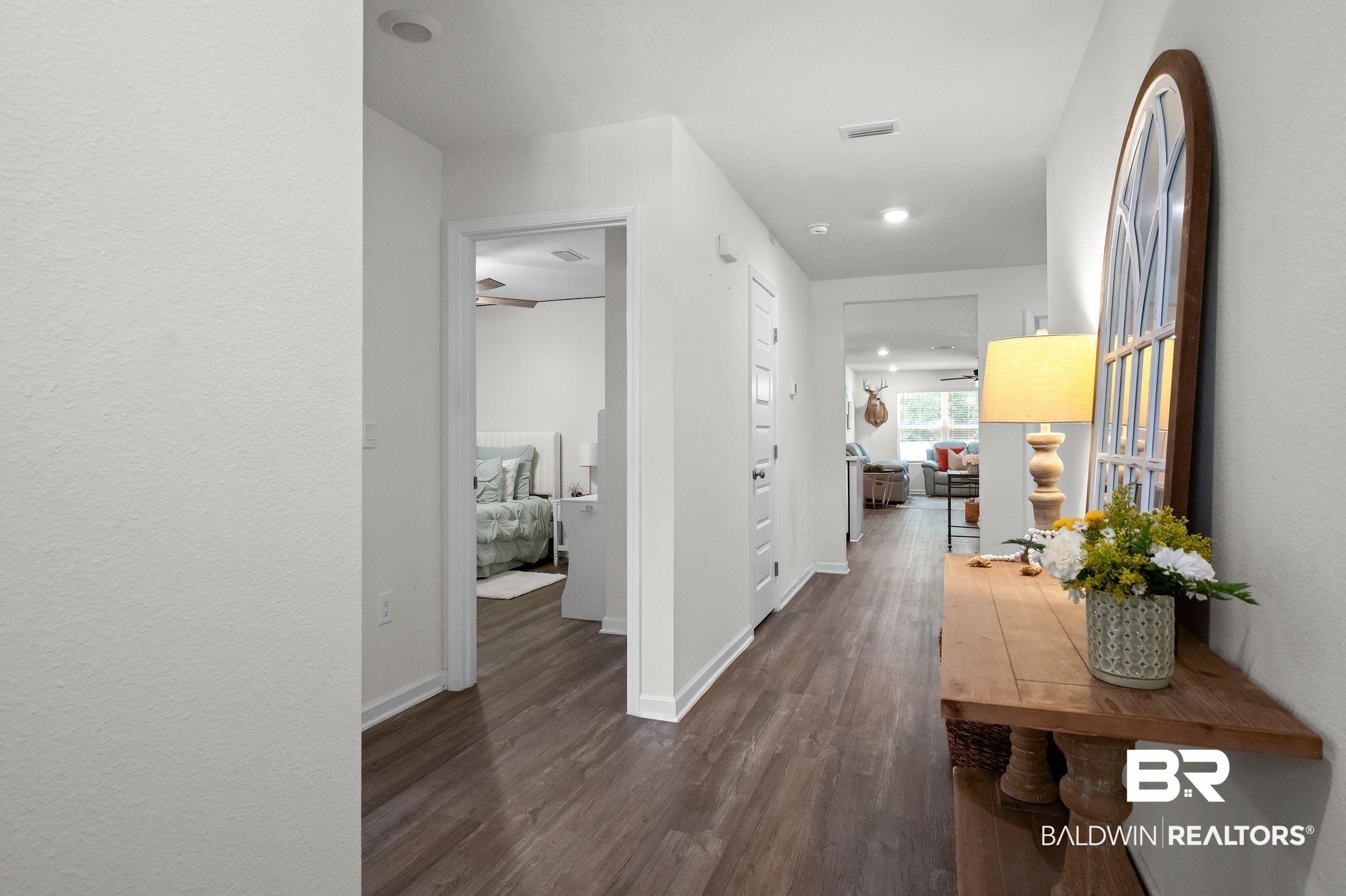 Image 4: Hallway featuring wood-finish flooring, recessed lighting, and white baseboards
