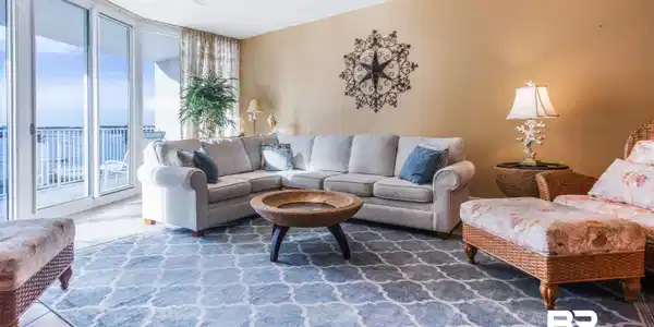 Image 4: Living area featuring tile patterned flooring, a wall of windows, and a ceiling fan