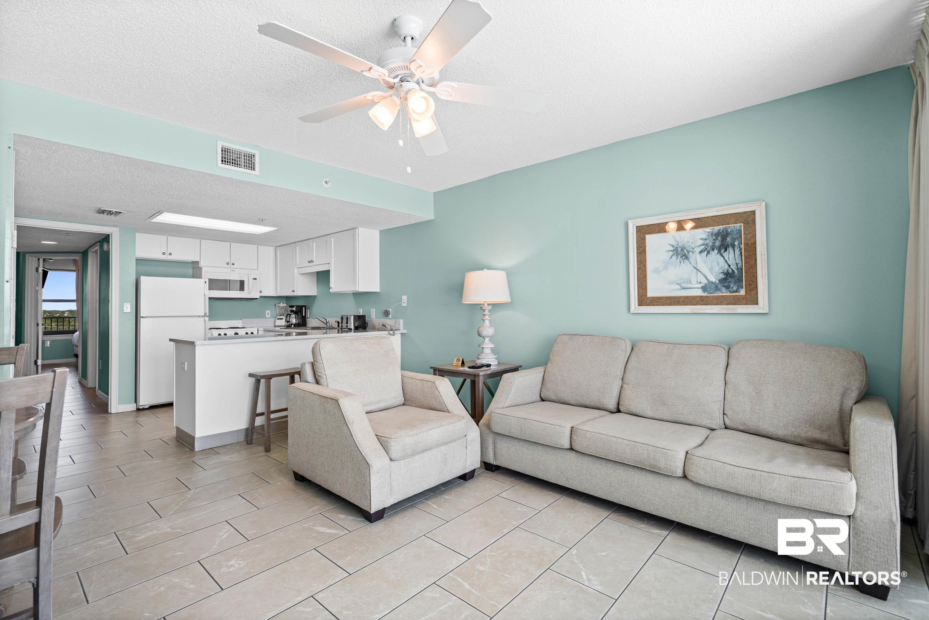 Image 4: Living area featuring a ceiling fan and a textured ceiling