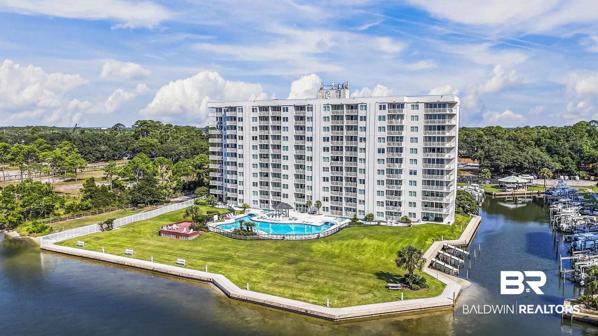 Image 3: Multi-story residential building with private balconies and a waterside location