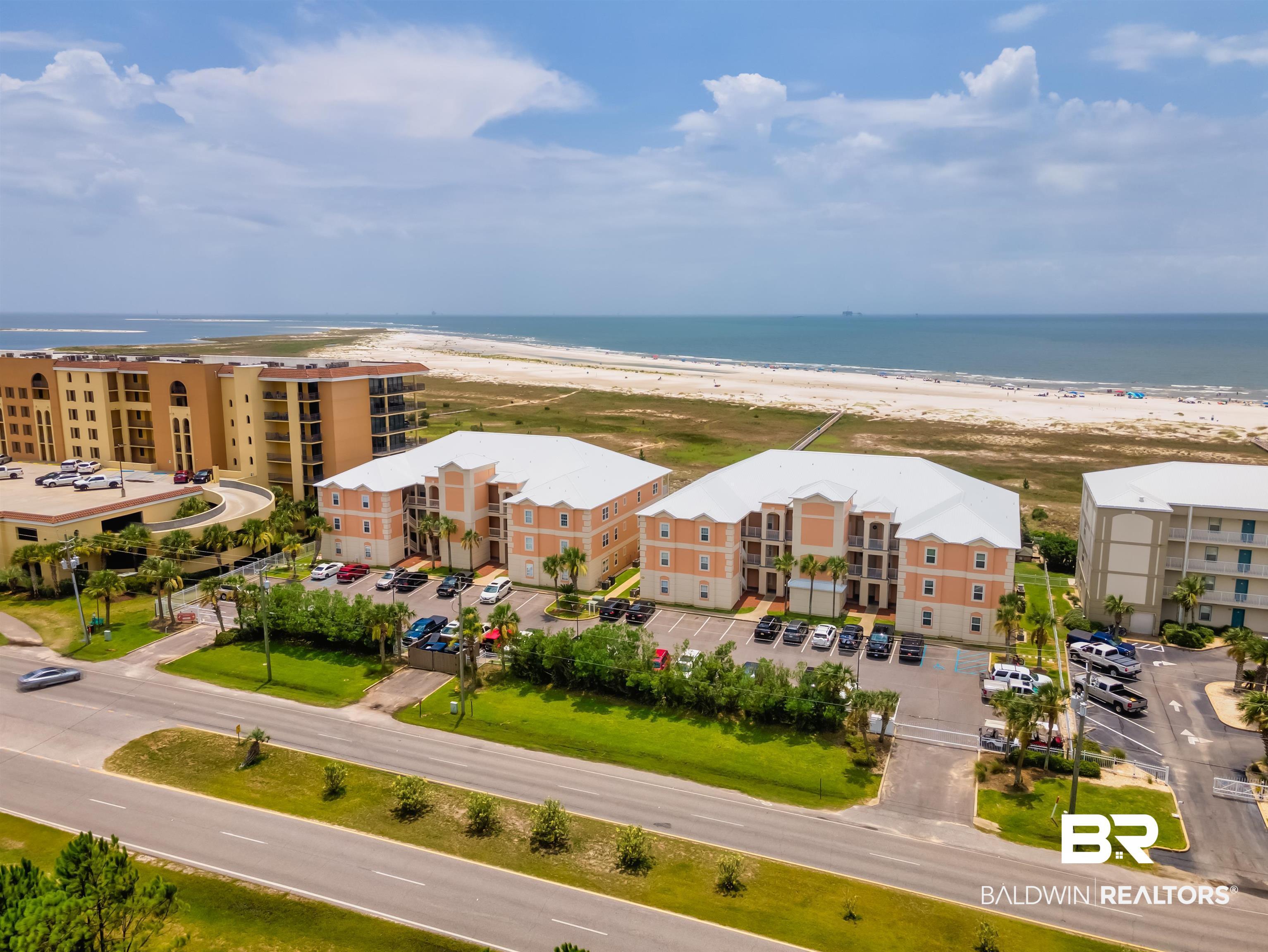 Image 1: Drone / aerial view featuring a water view and a beach view