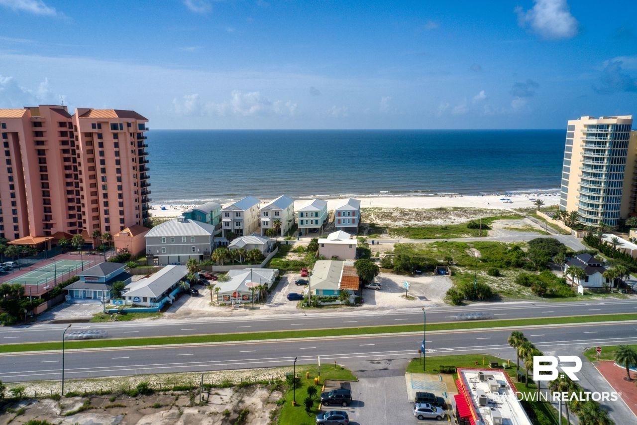 Image 2: Aerial view featuring a water view and a beach view