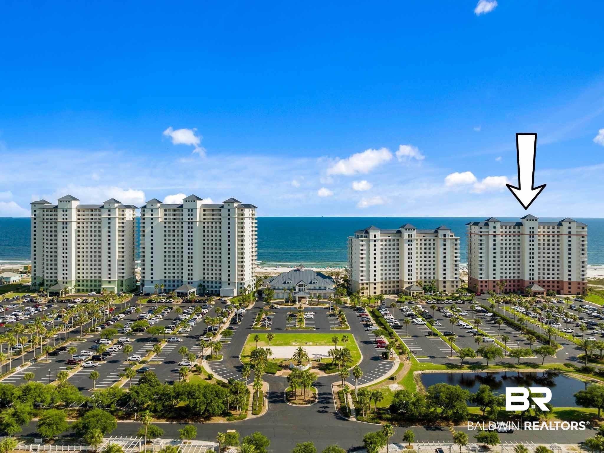 Image 2: Drone / aerial view of a nearby body of water and apartment complex