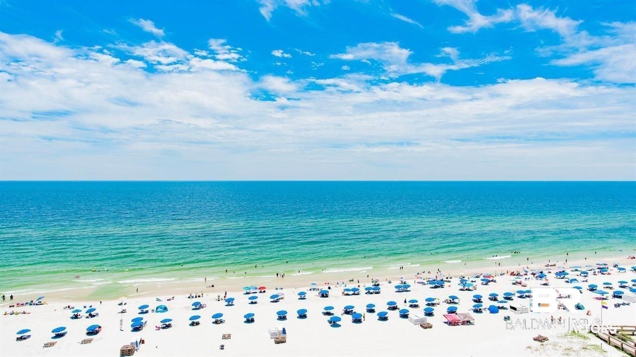 Image 2: Expansive white sand beach with turquoise ocean waters extending to the horizon