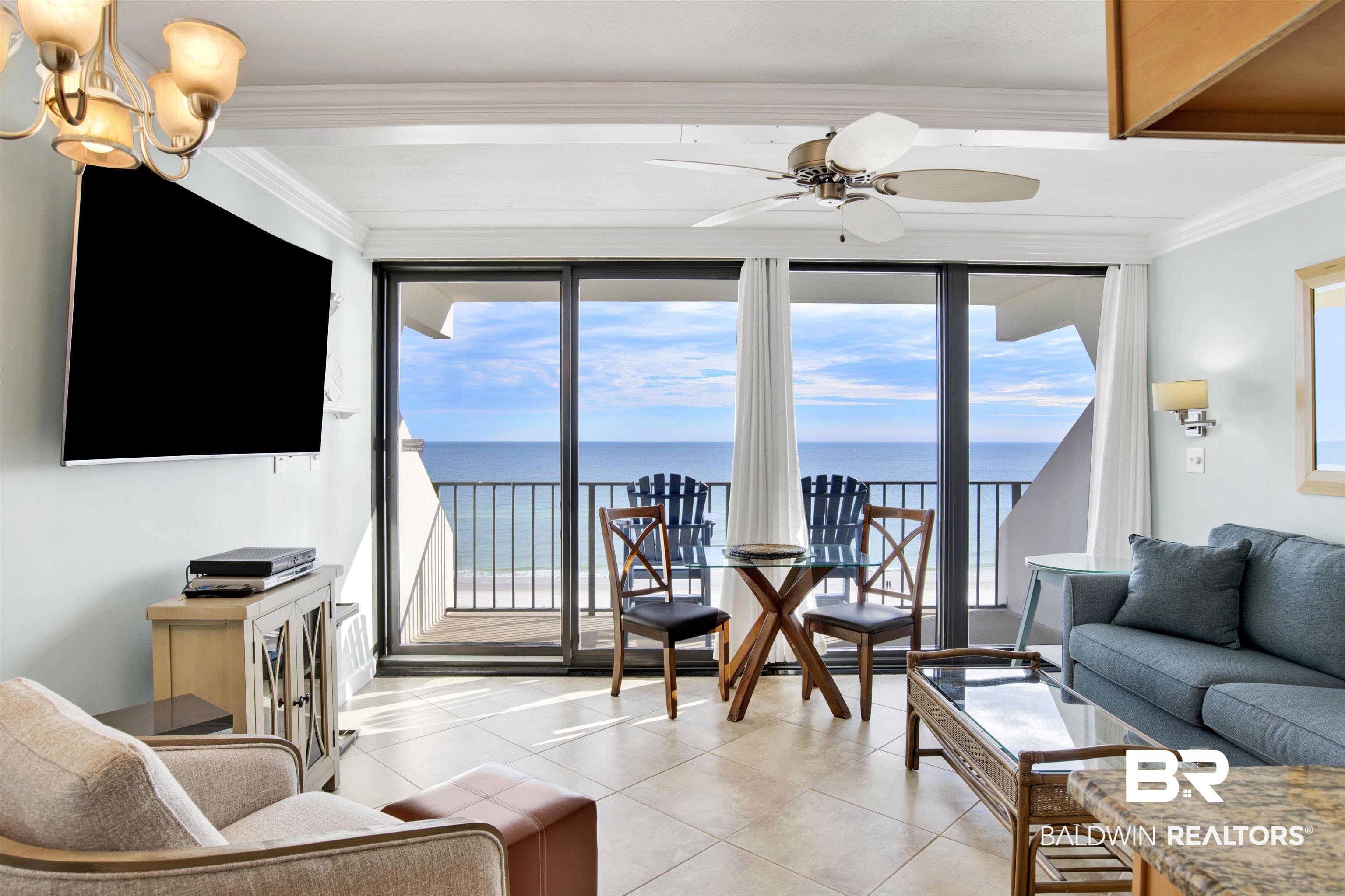 Image 2: Overlooking the Gulf of America. 65" Samsung UHD curved screen TV with hidden cable/internet wiring. Double crown molding. Beautiful tile flooring. Wall sconces. Ceiling fan with light.
