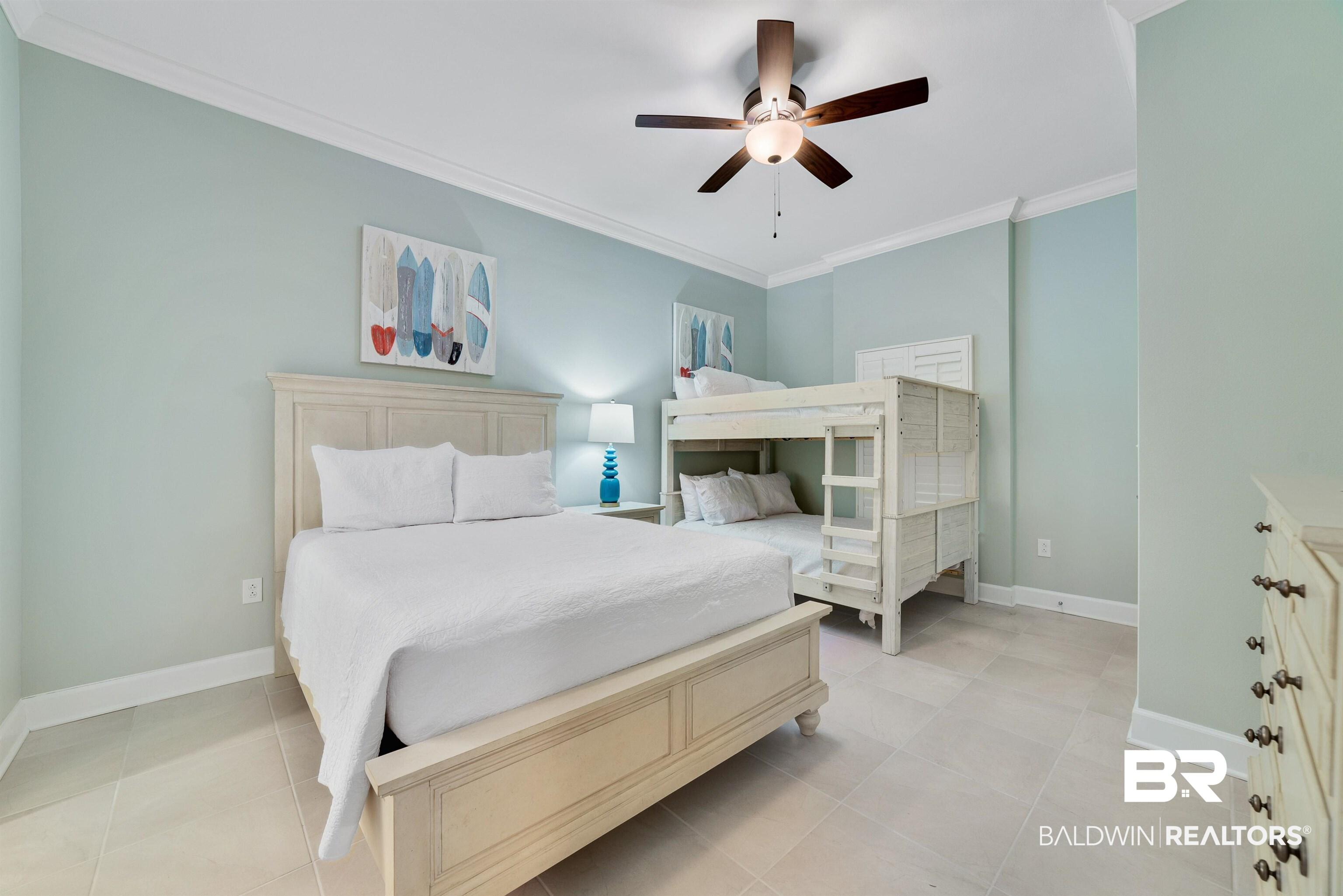 Image 3: Bedroom with a ceiling fan, baseboards, crown molding, and light tile patterned flooring