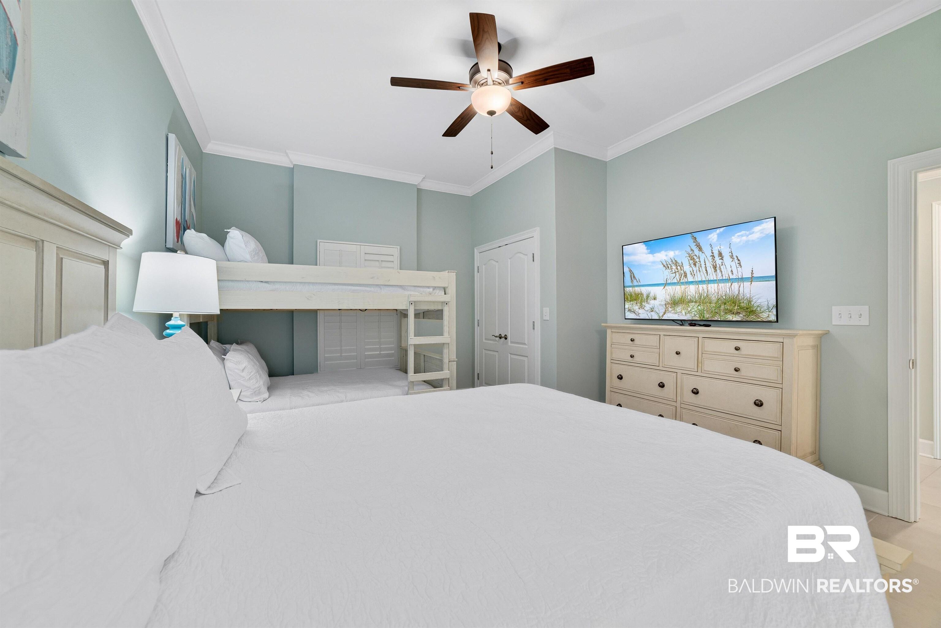 Image 4: Bedroom with ornamental molding, ceiling fan, and baseboards