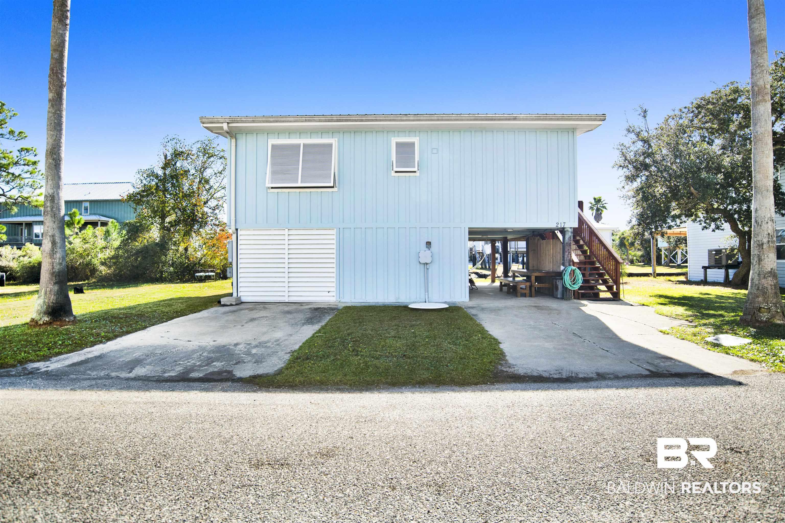 Image 2: View of home's exterior with stairway and a yard