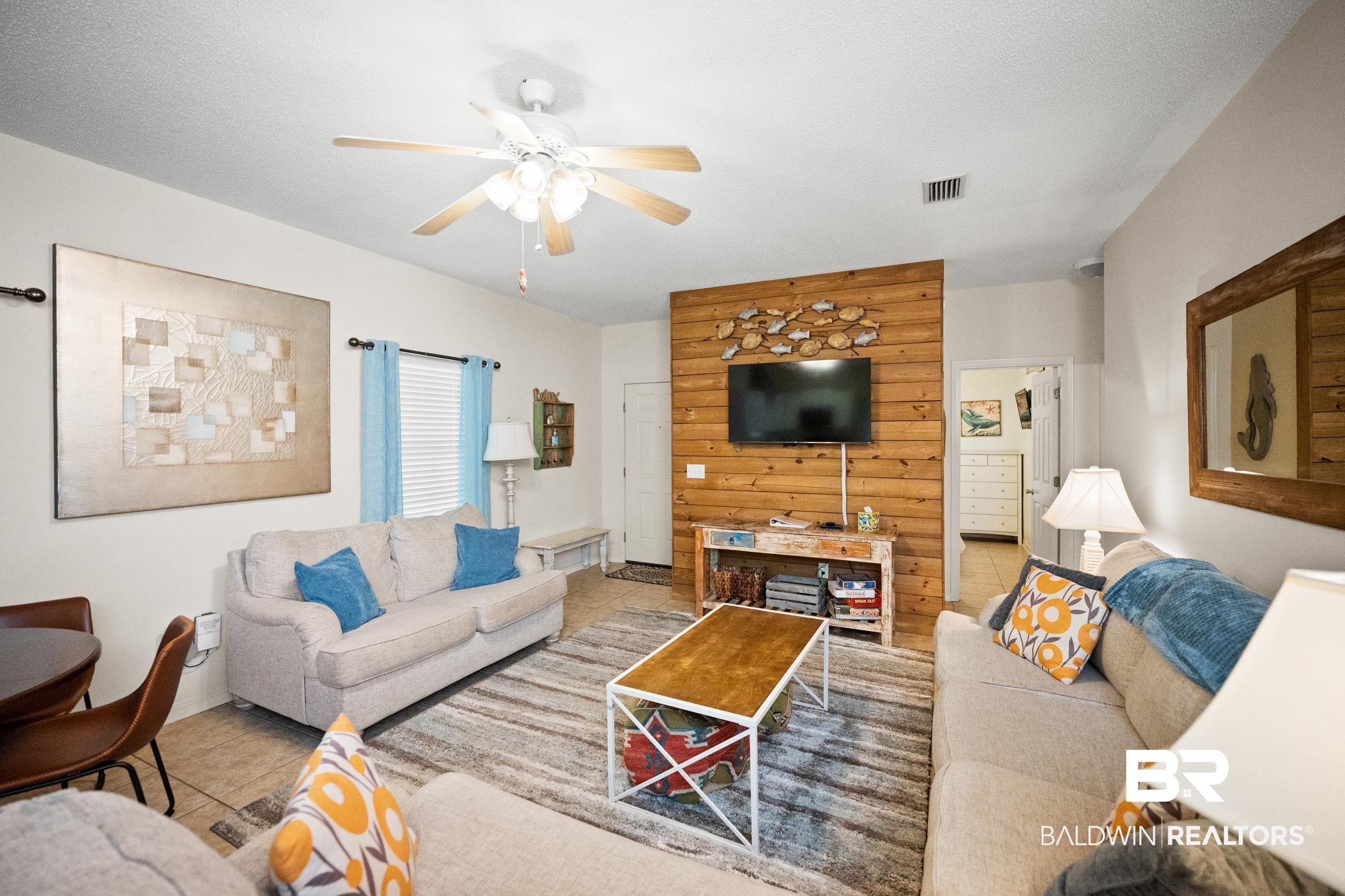 Image 2: Tiled living room featuring ceiling fan