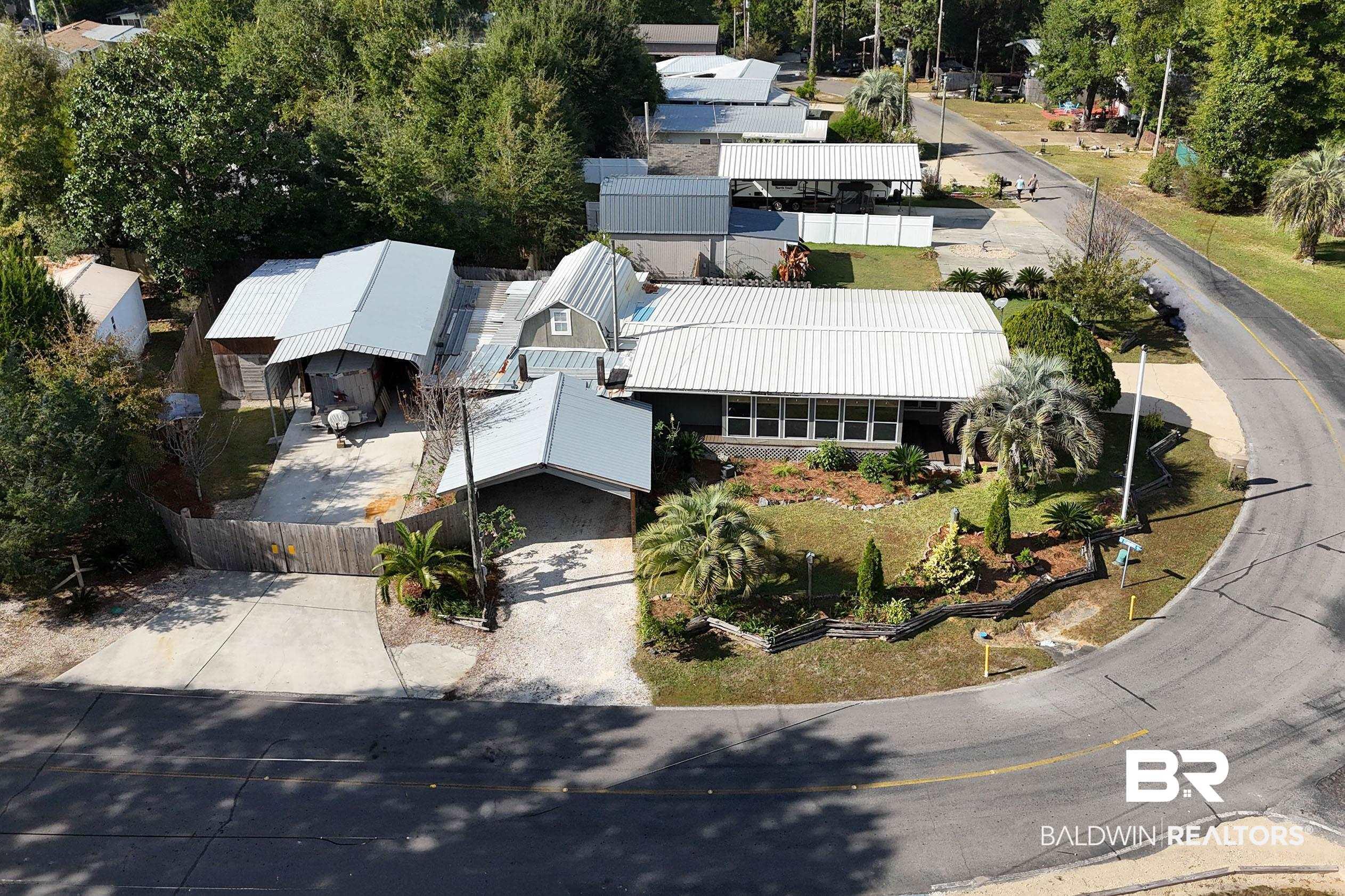 Image 1: View of subject property that sits on 3 lots on the corner