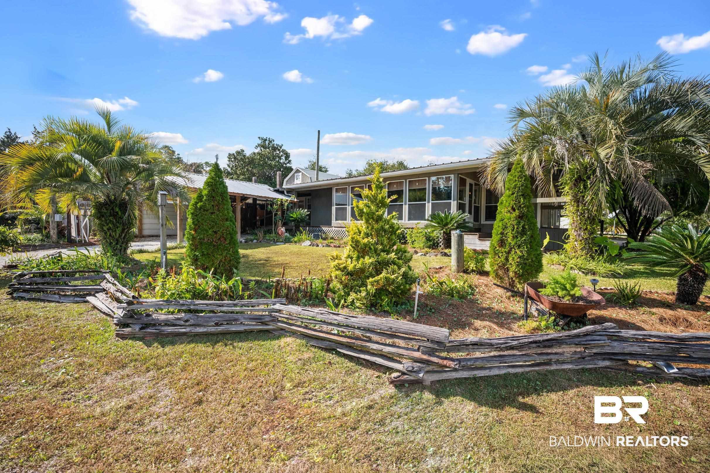 Image 2: View of yard and exterior of home that sits on the corner on 3 lots