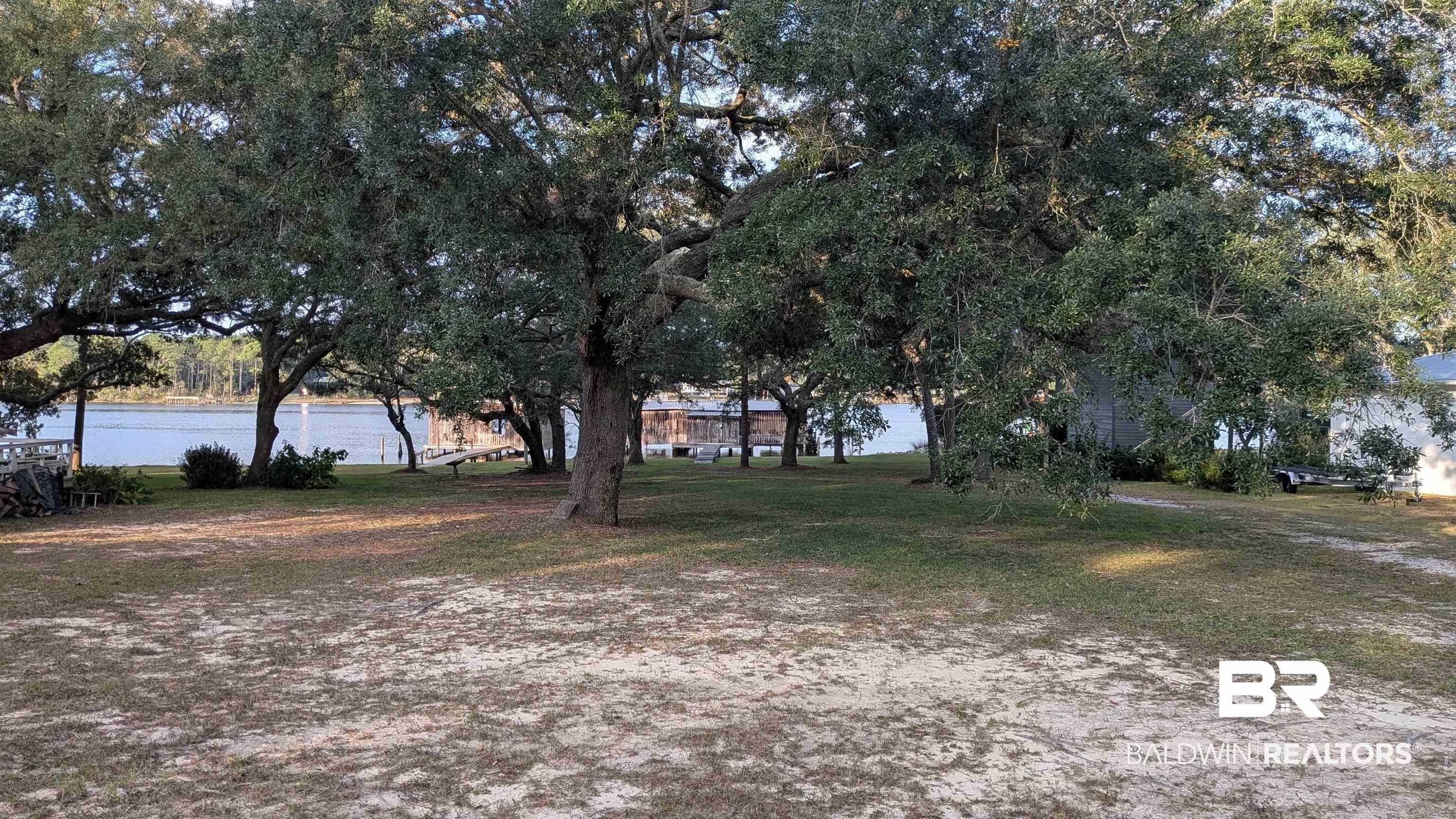 Image 3: View of grassy yard with a water view