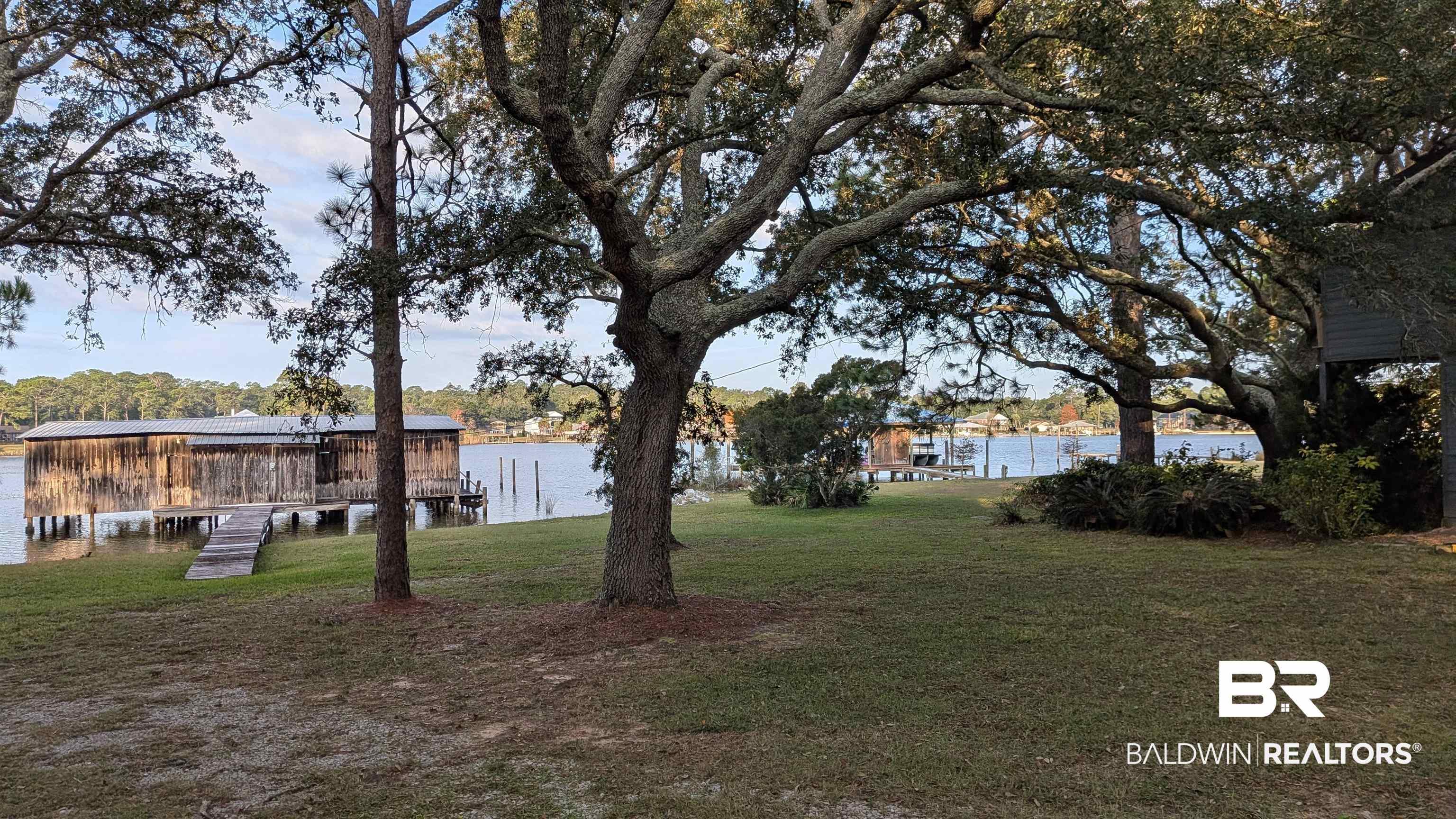 Image 4: View of grassy yard with a boat dock and a water view