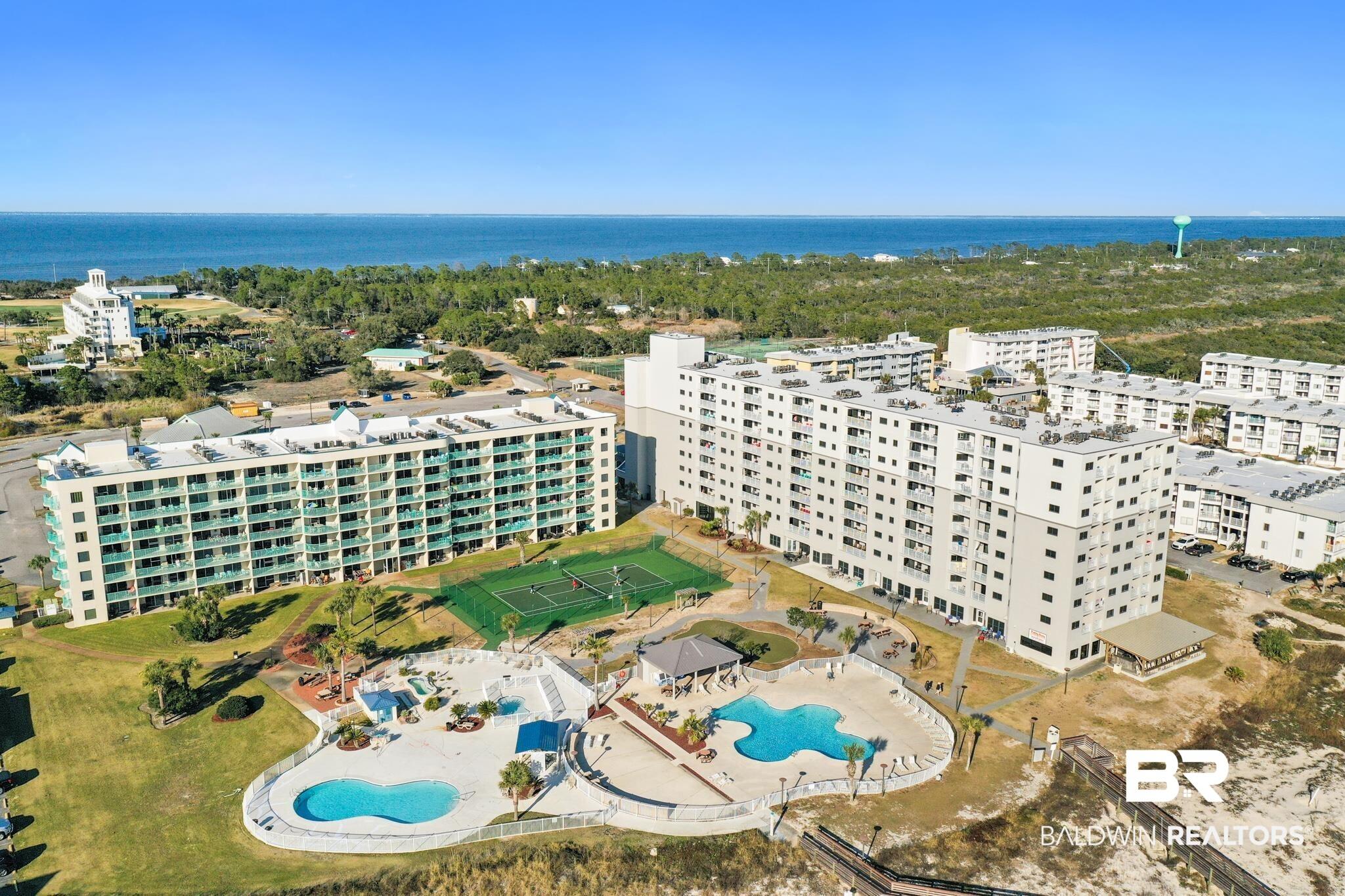 Image 1: Aerial view of a pool and apartment complex