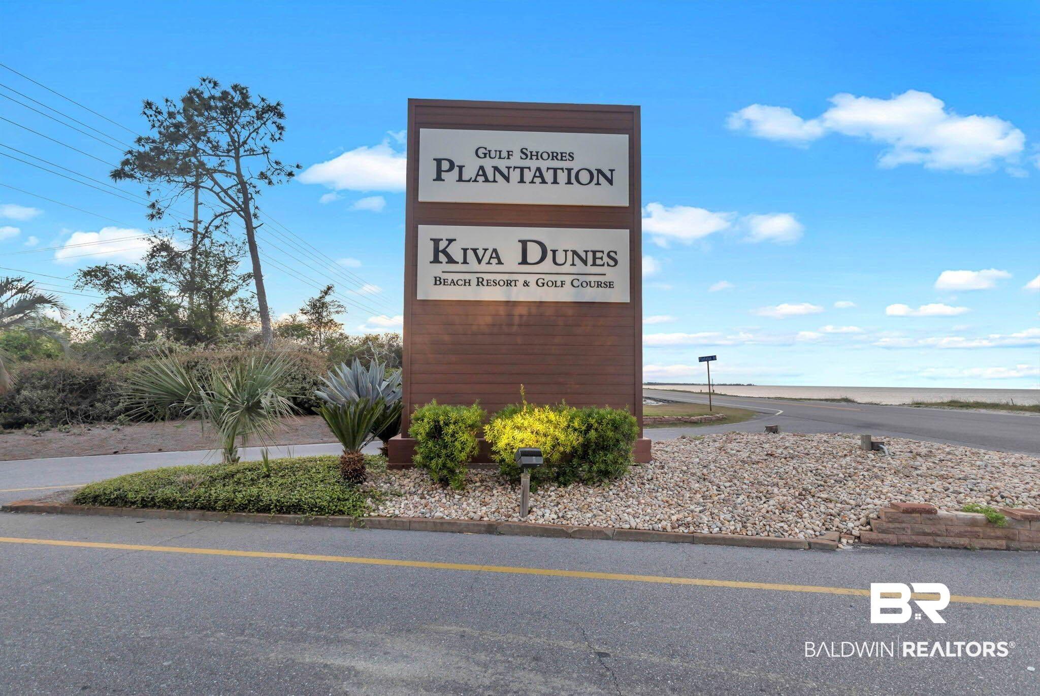 Image 2: Wood-finish signage with prominent lettering, set against a backdrop of mature trees and landscaping
