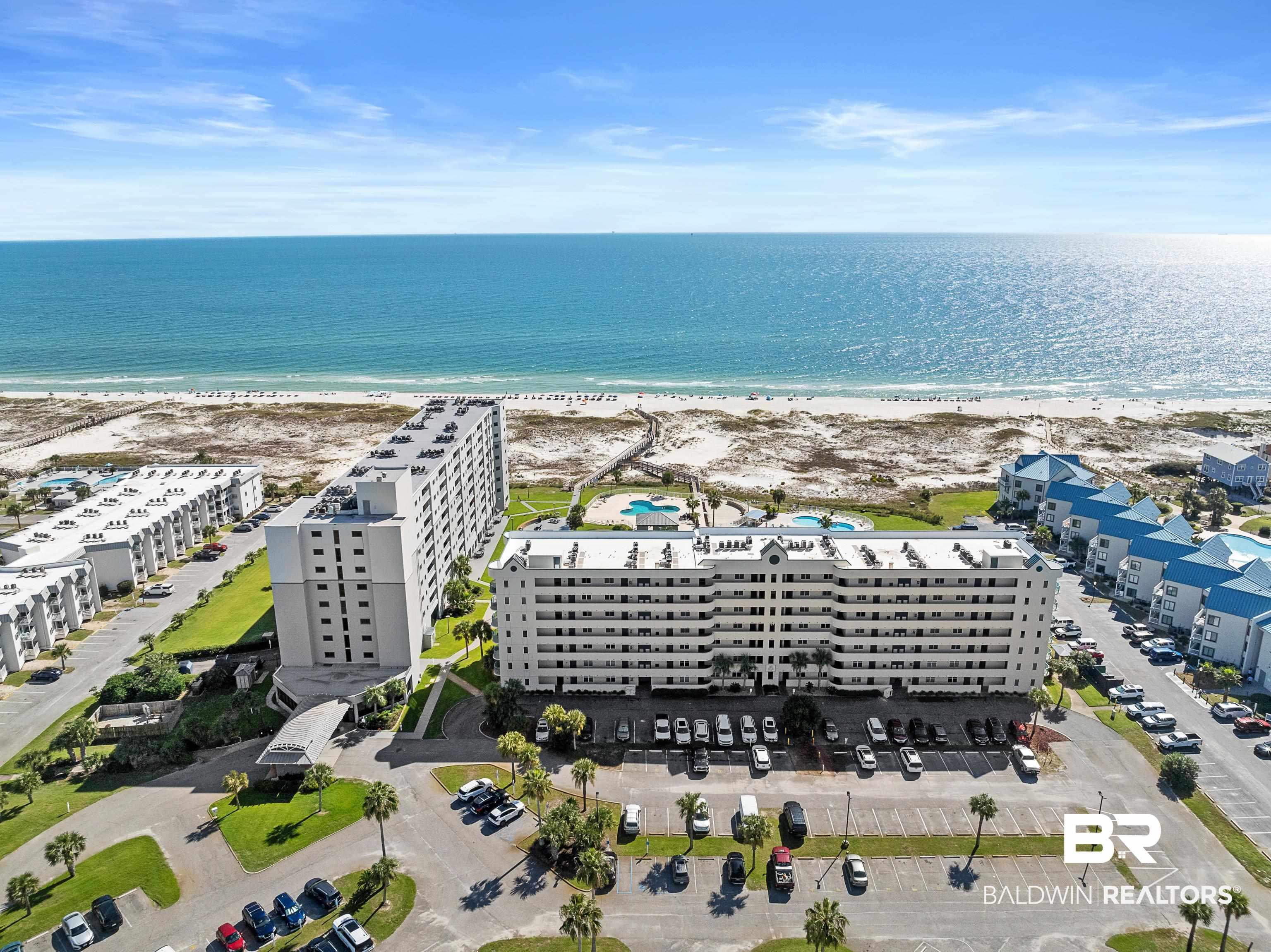 Image 3: Drone / aerial view of extended coastline and apartment complex / building