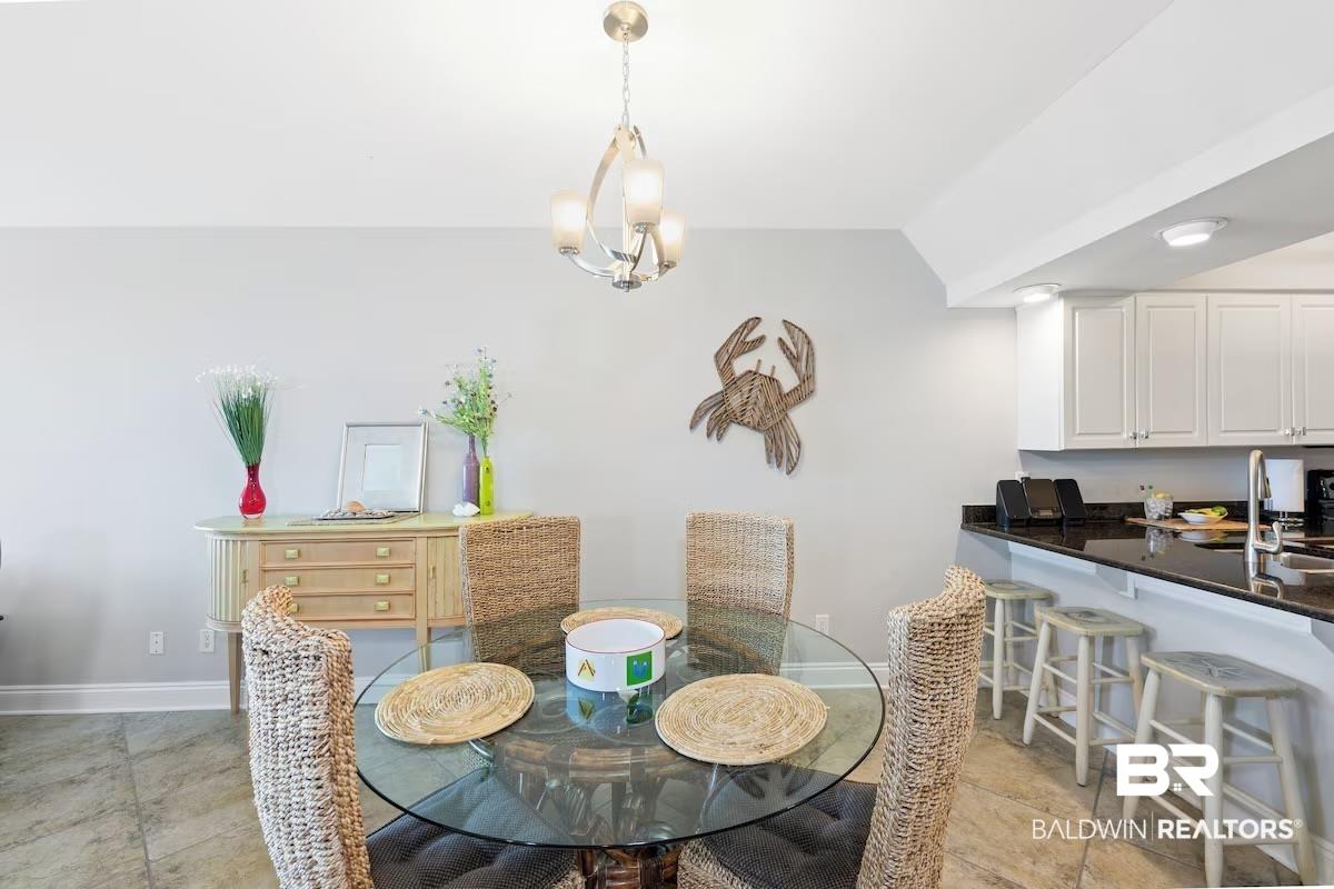 Image 3: Dining room with vaulted ceiling and hanging lights