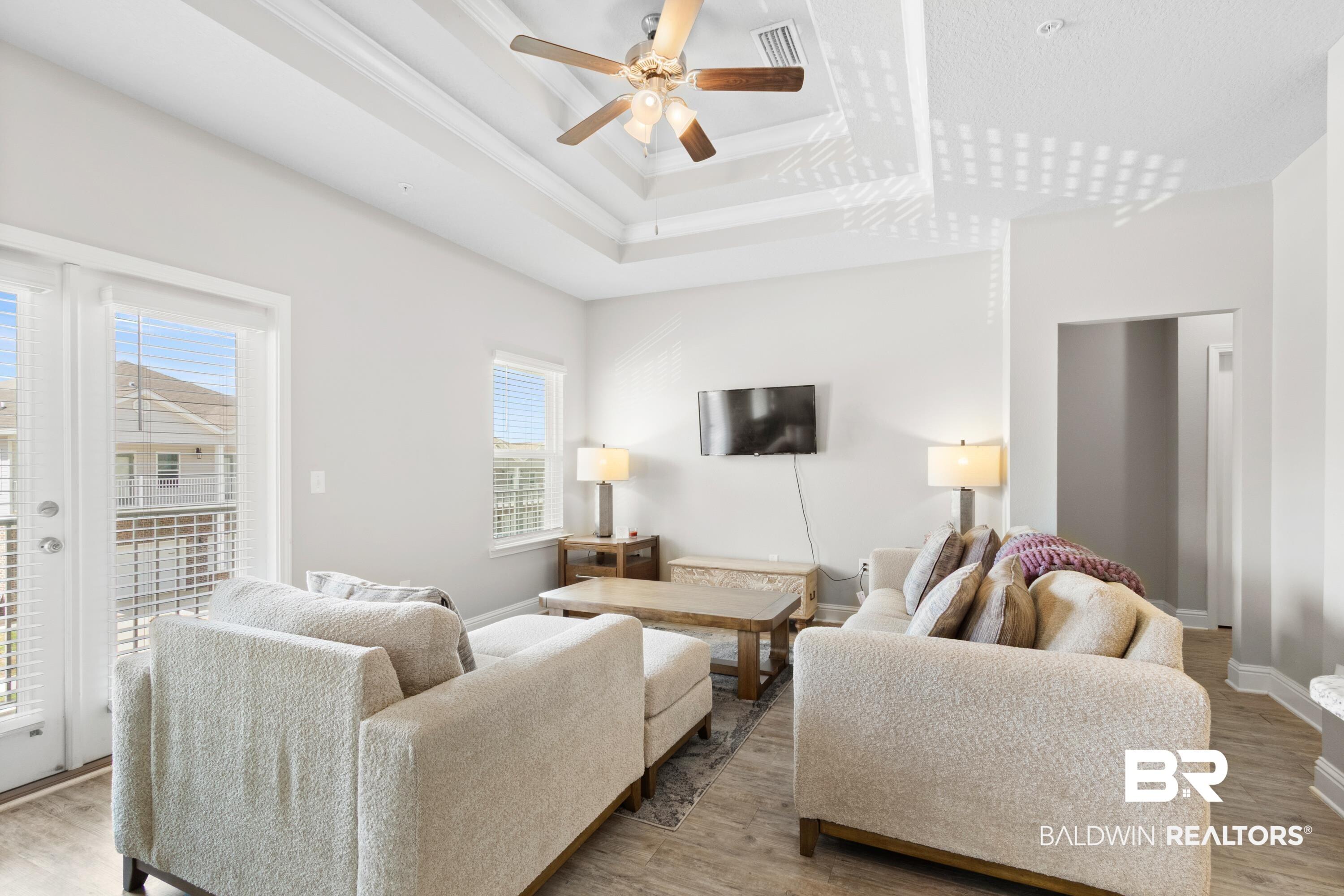Image 2: Living area featuring wood finished floors, a ceiling fan, and ornamental molding