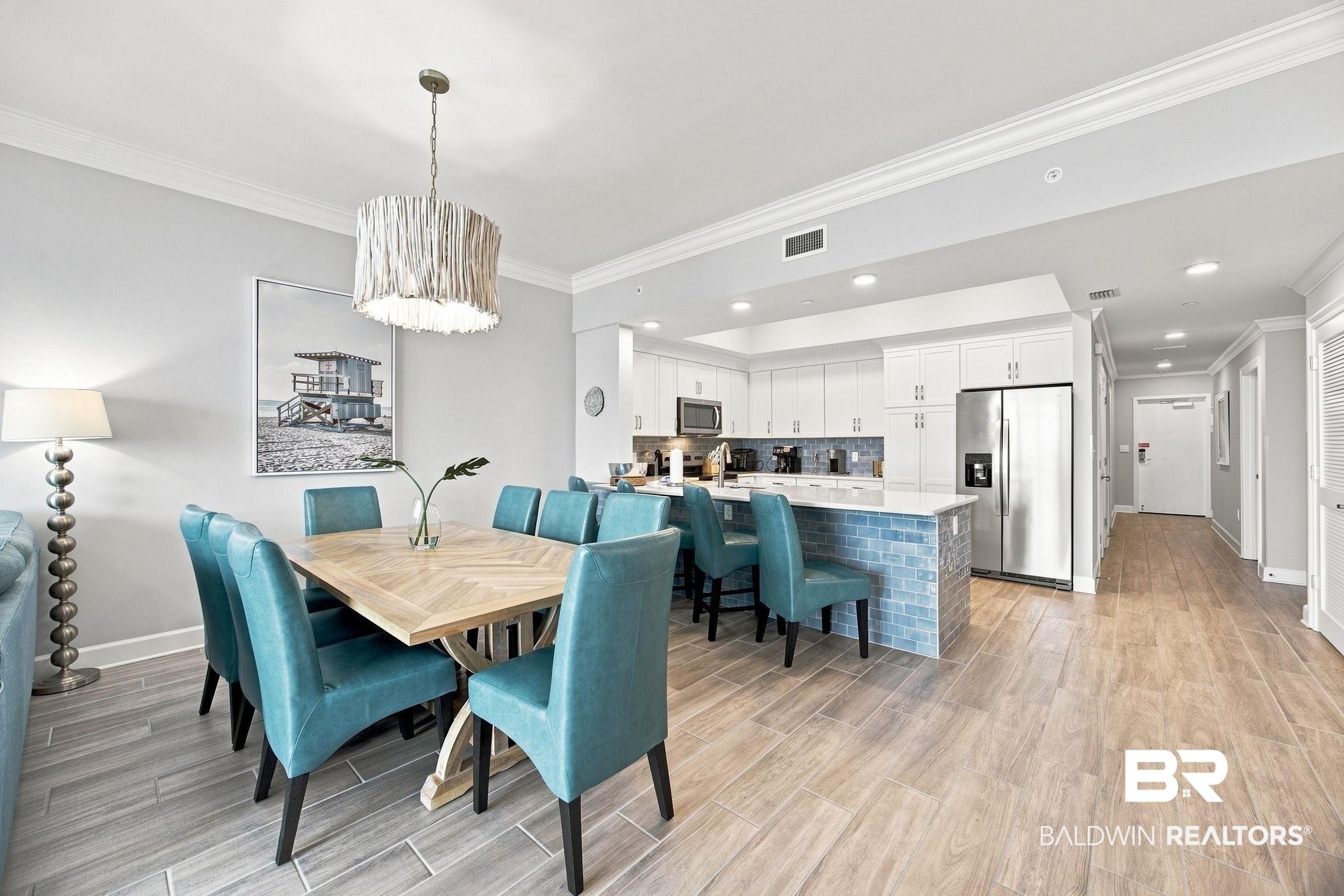 Image 4: Open-concept living space featuring wood-finish flooring, crown molding, and recessed lighting