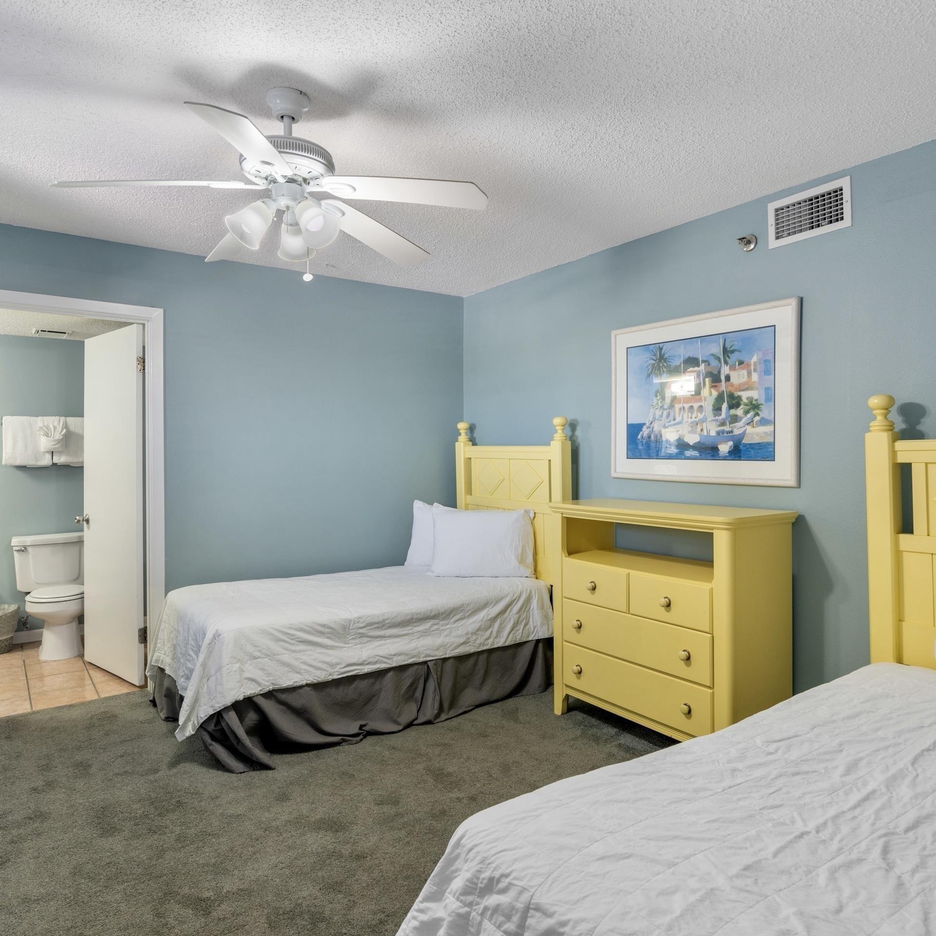 Image 3: Carpeted bedroom with visible vents, connected bathroom, tile patterned floors, a textured ceiling, and a ceiling fan